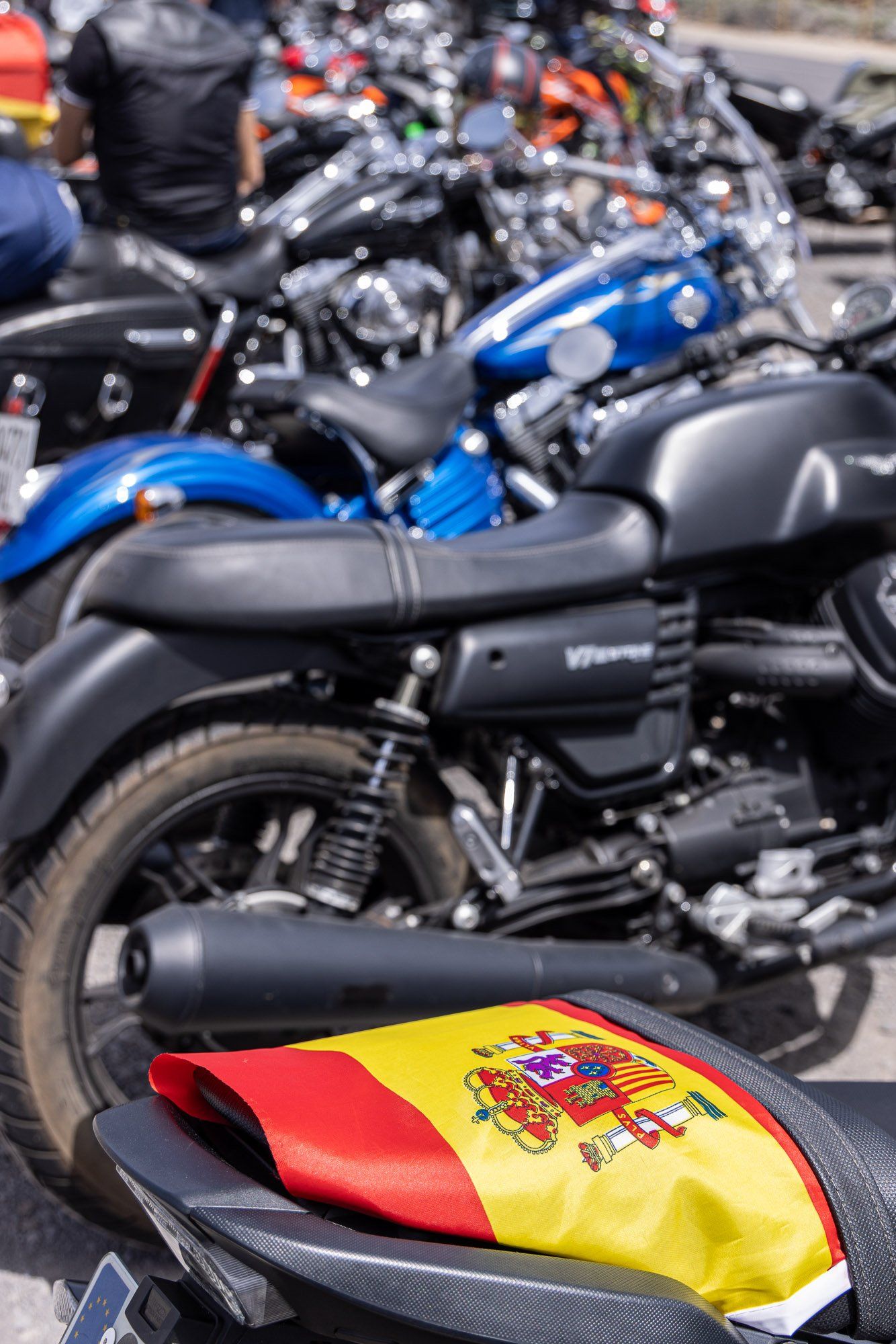 A motorcycle with a spanish flag on the back of it
