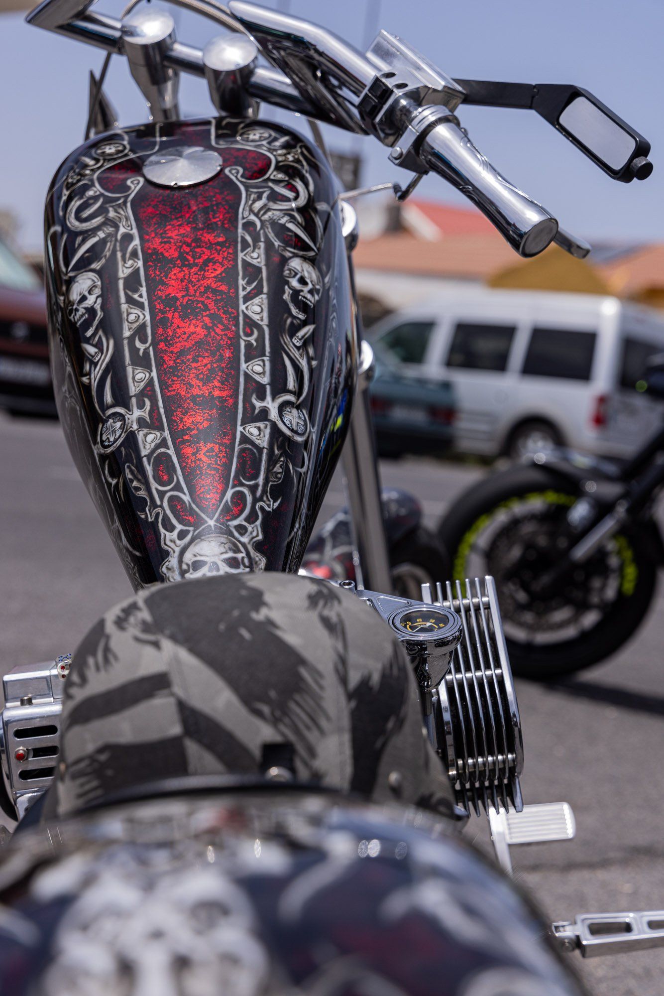 A motorcycle with skulls painted on it is parked in a parking lot