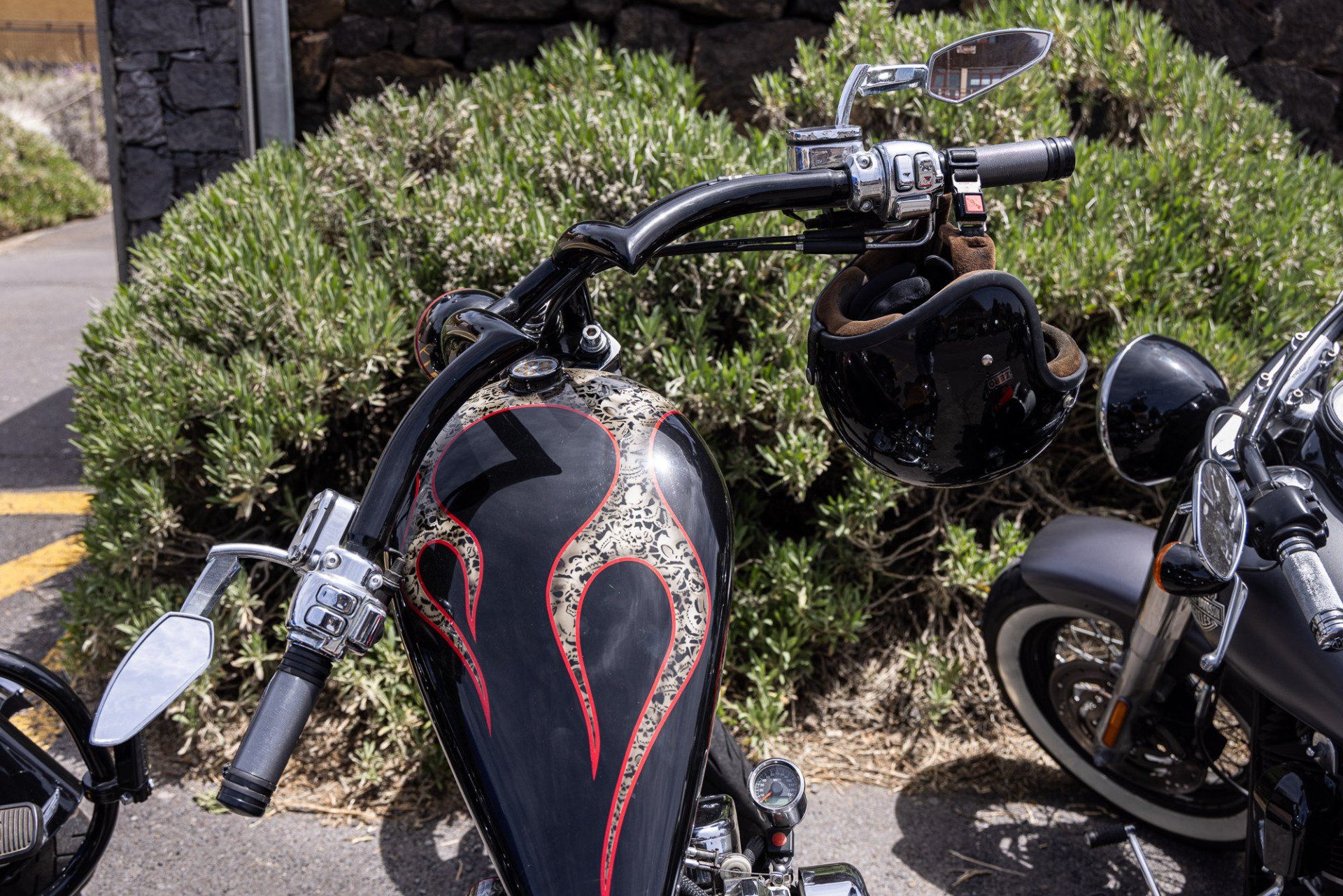 Two motorcycles are parked next to each other on the side of the road.