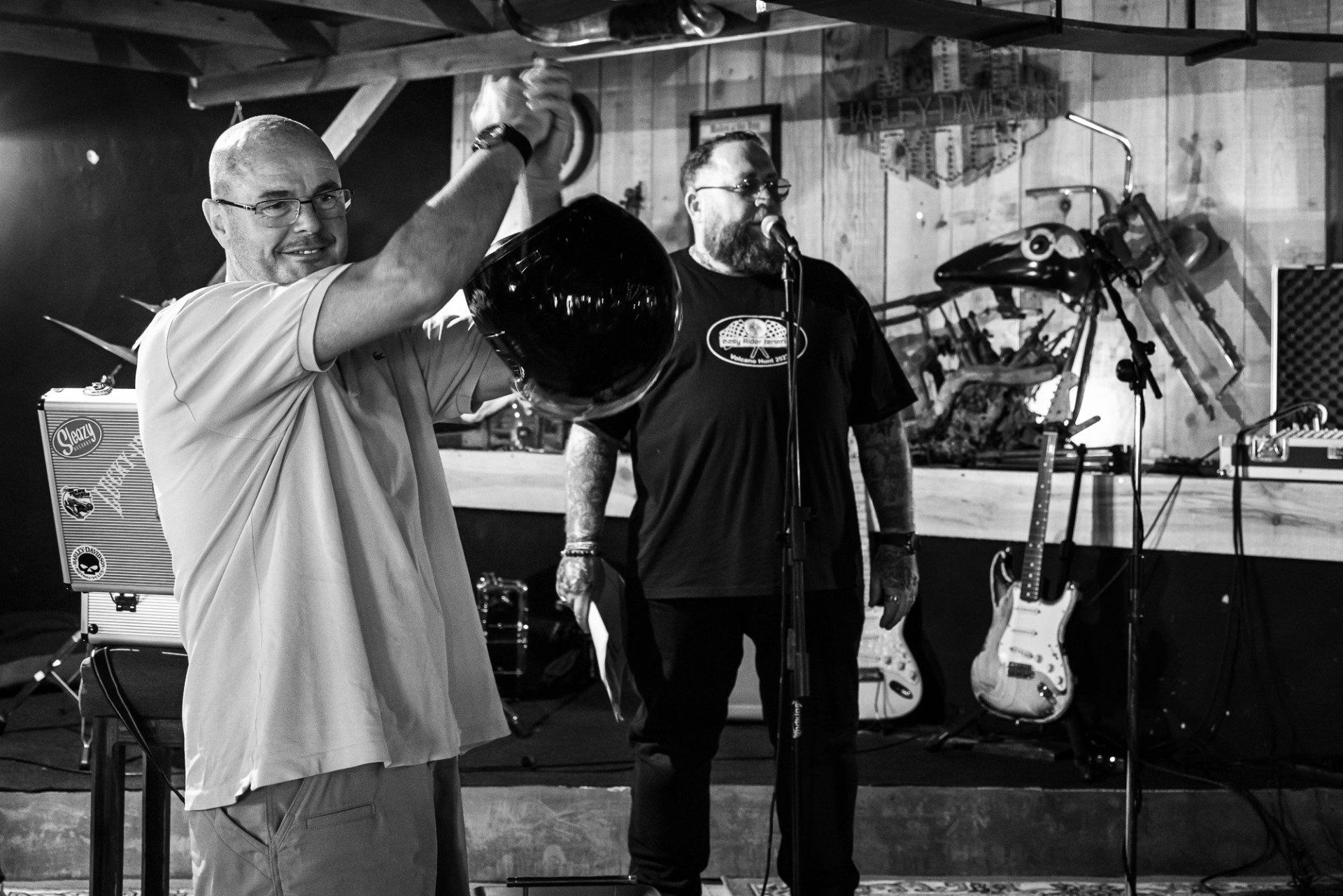 Two men are playing instruments in a black and white photo.