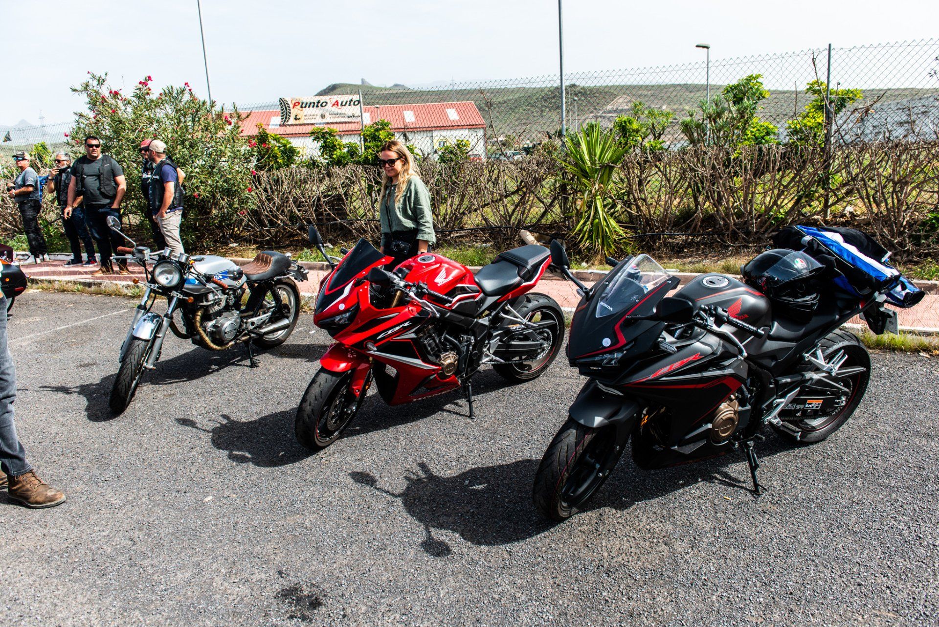 A group of motorcycles are parked on the side of the road.