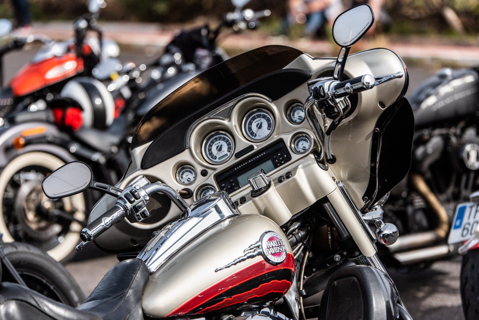 A row of motorcycles are parked on the side of the road.