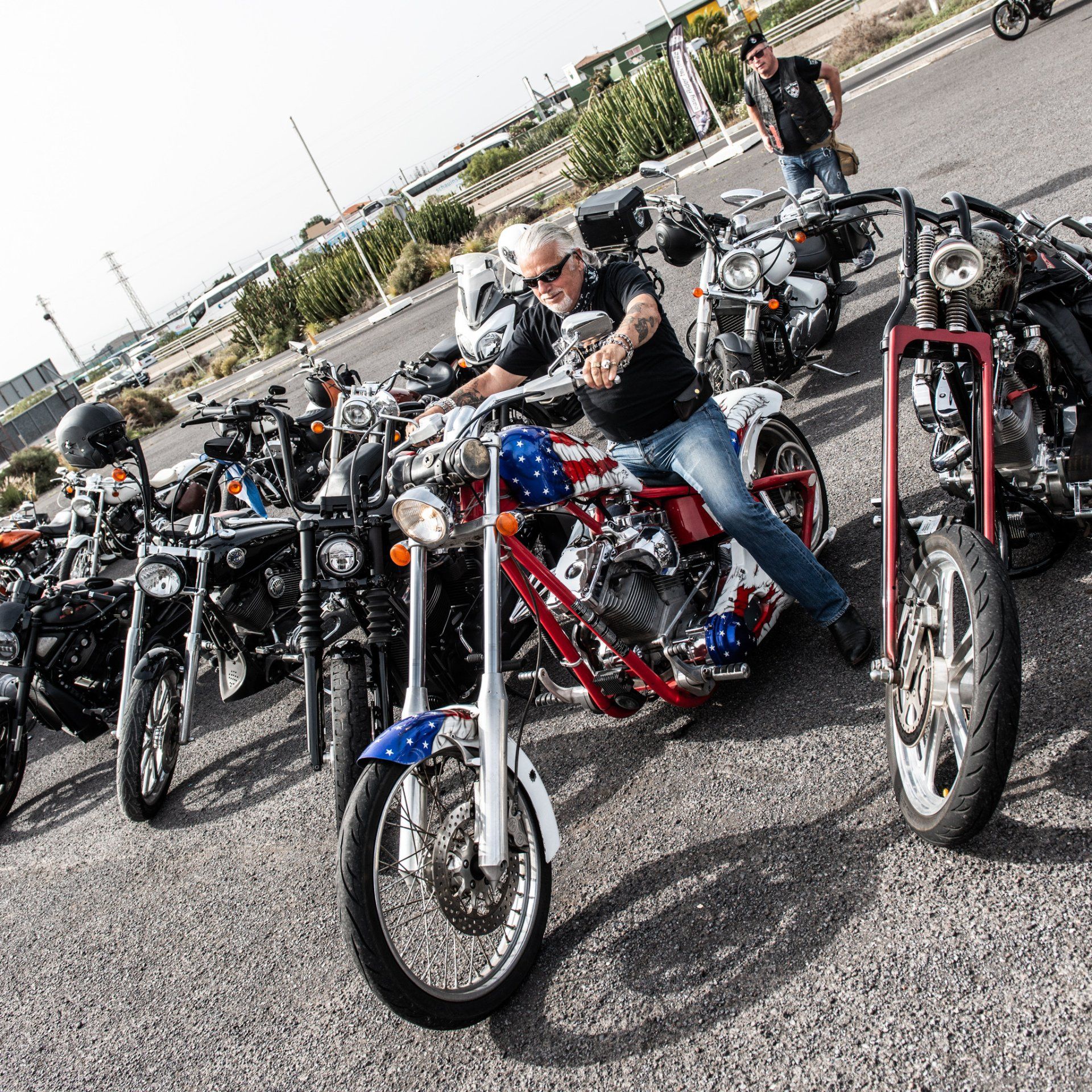 A group of motorcycles are parked on the side of the road.