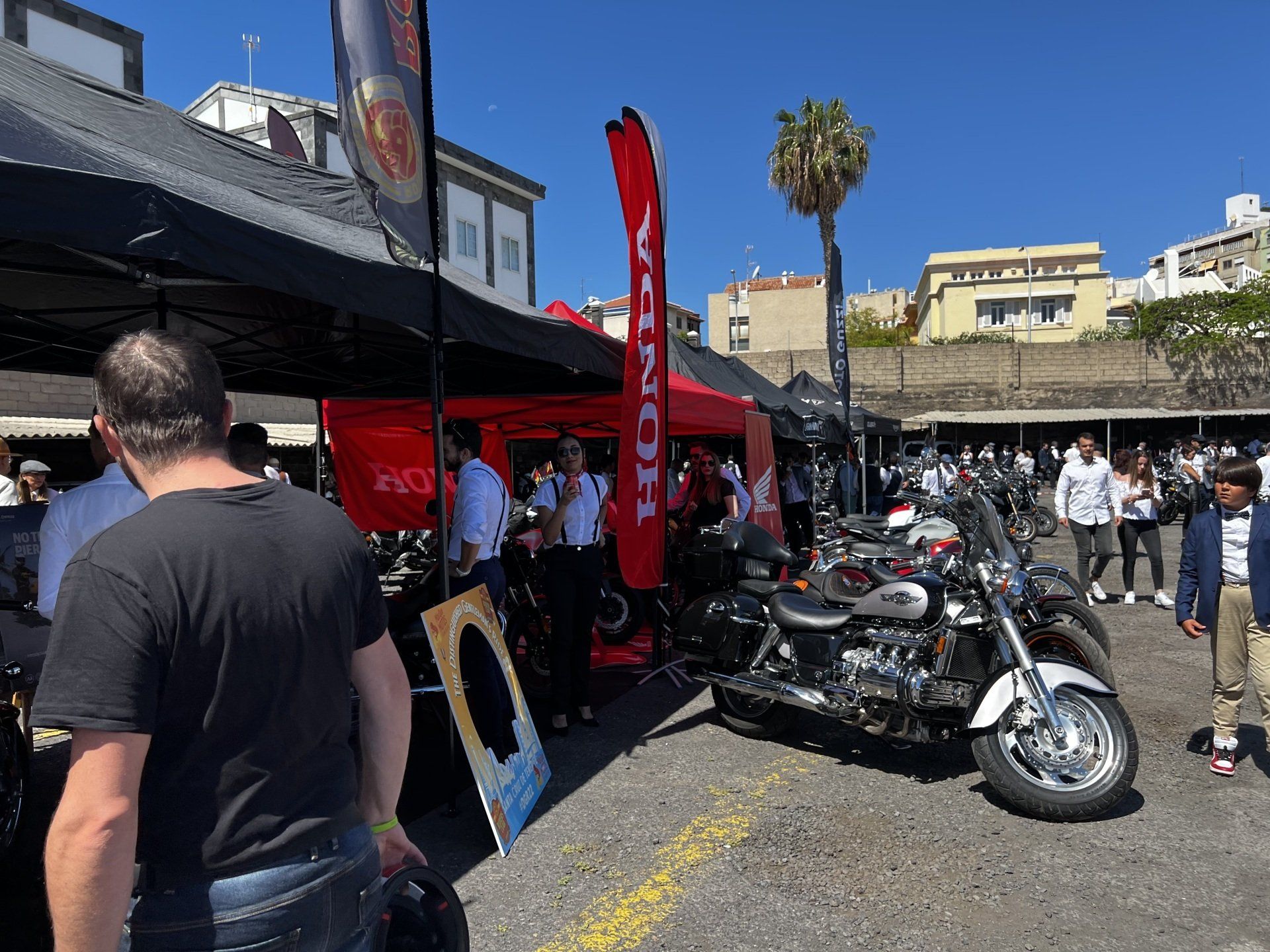 A man is standing in front of a motorcycle dealership