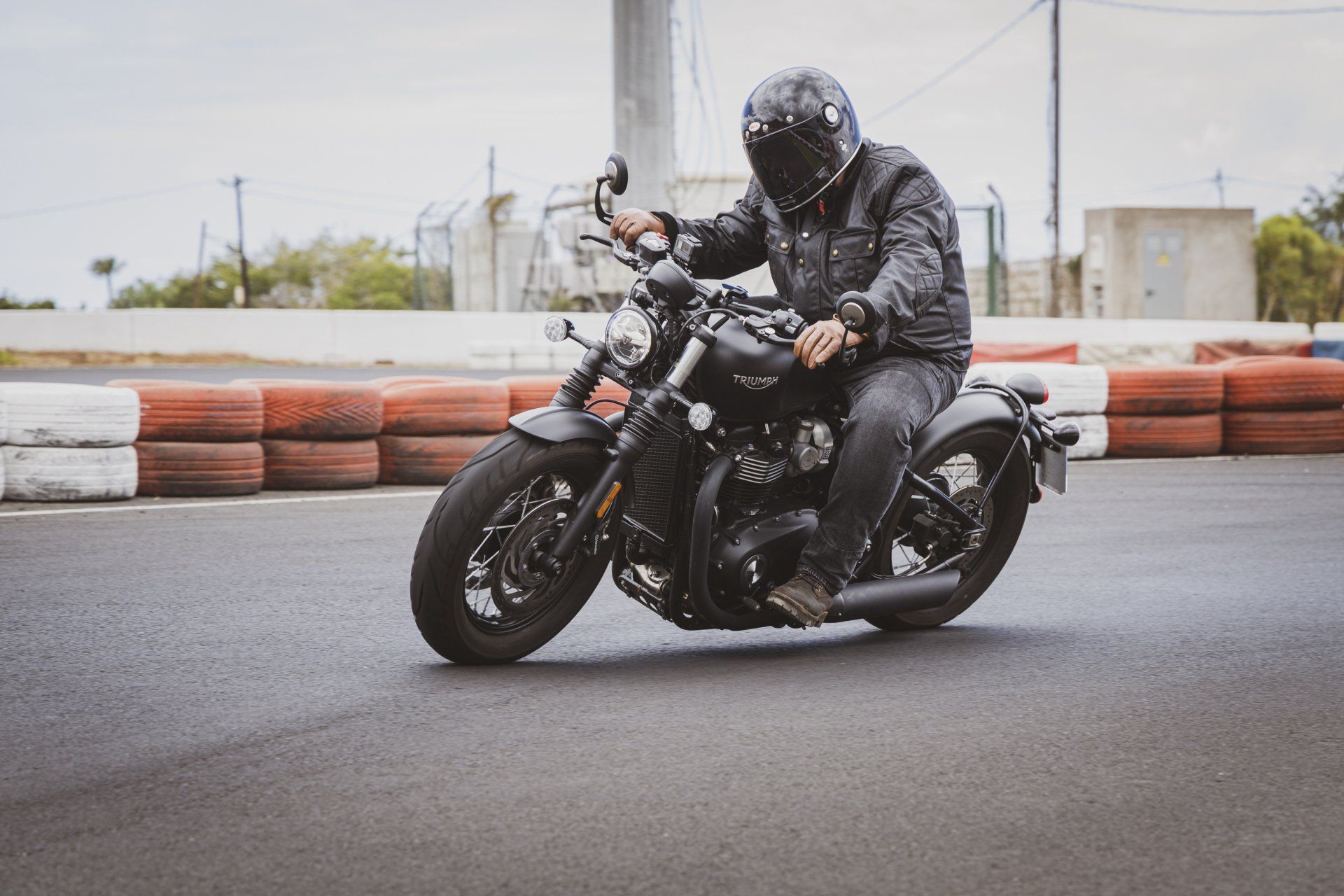 A man is riding a motorcycle on a race track.