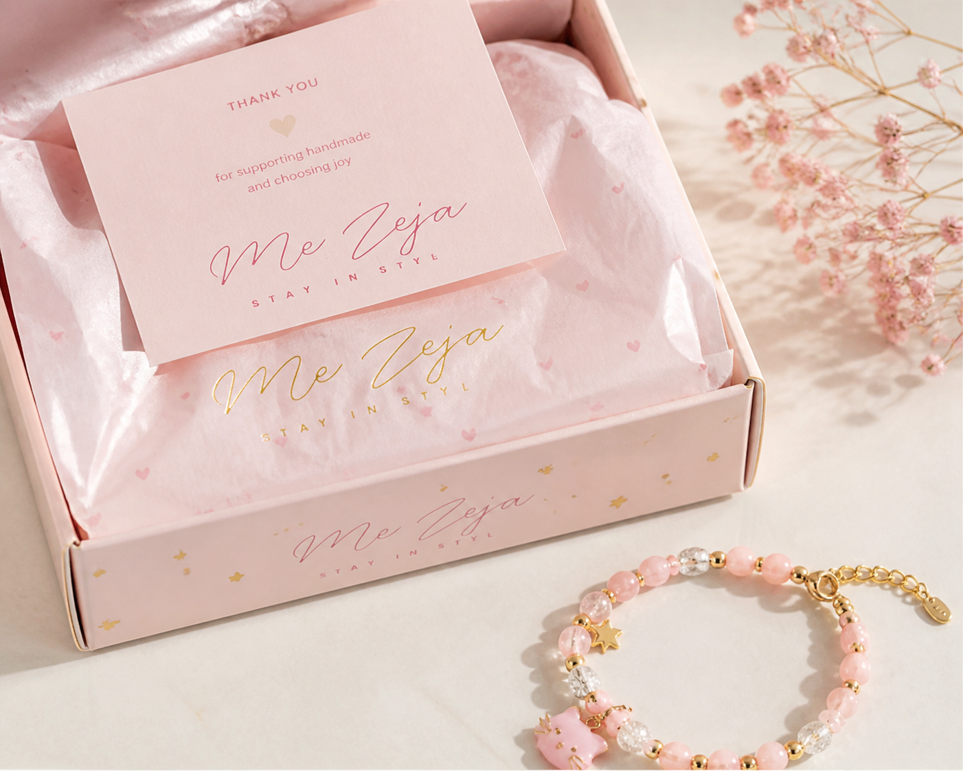 Pastel pink gift box with tissue paper and jewelry bracelet on a soft, decorative surface
