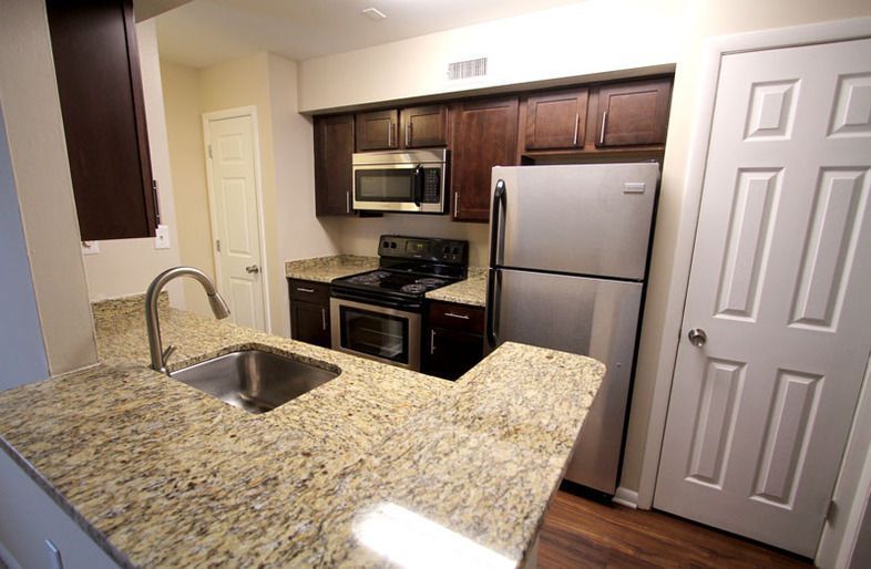 A kitchen with granite counter tops and stainless steel appliances