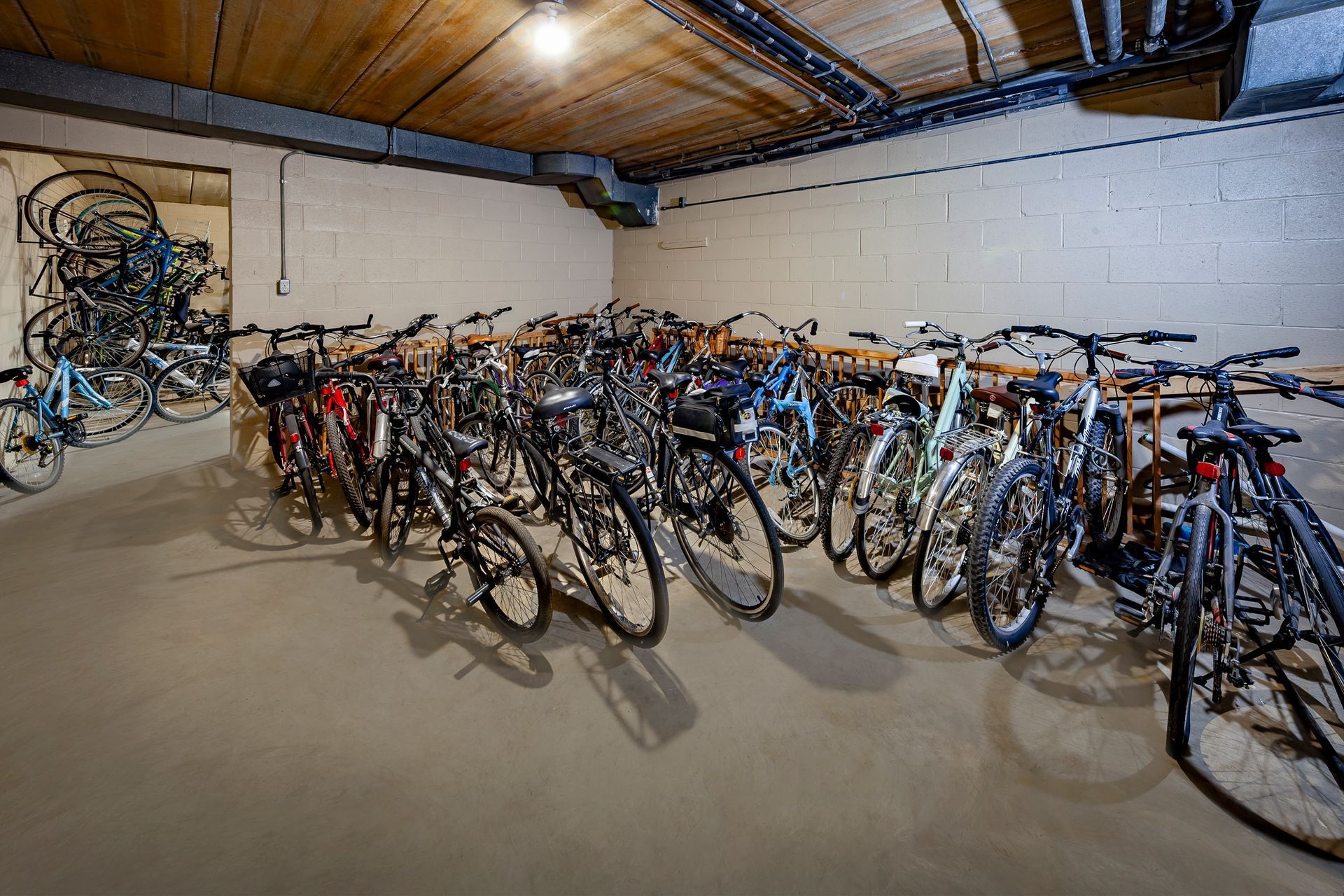 A bunch of bicycles are parked in a garage.