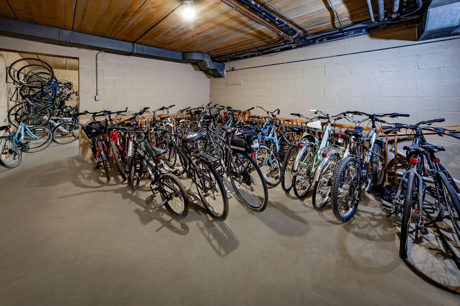 A bunch of bicycles are parked in a garage.