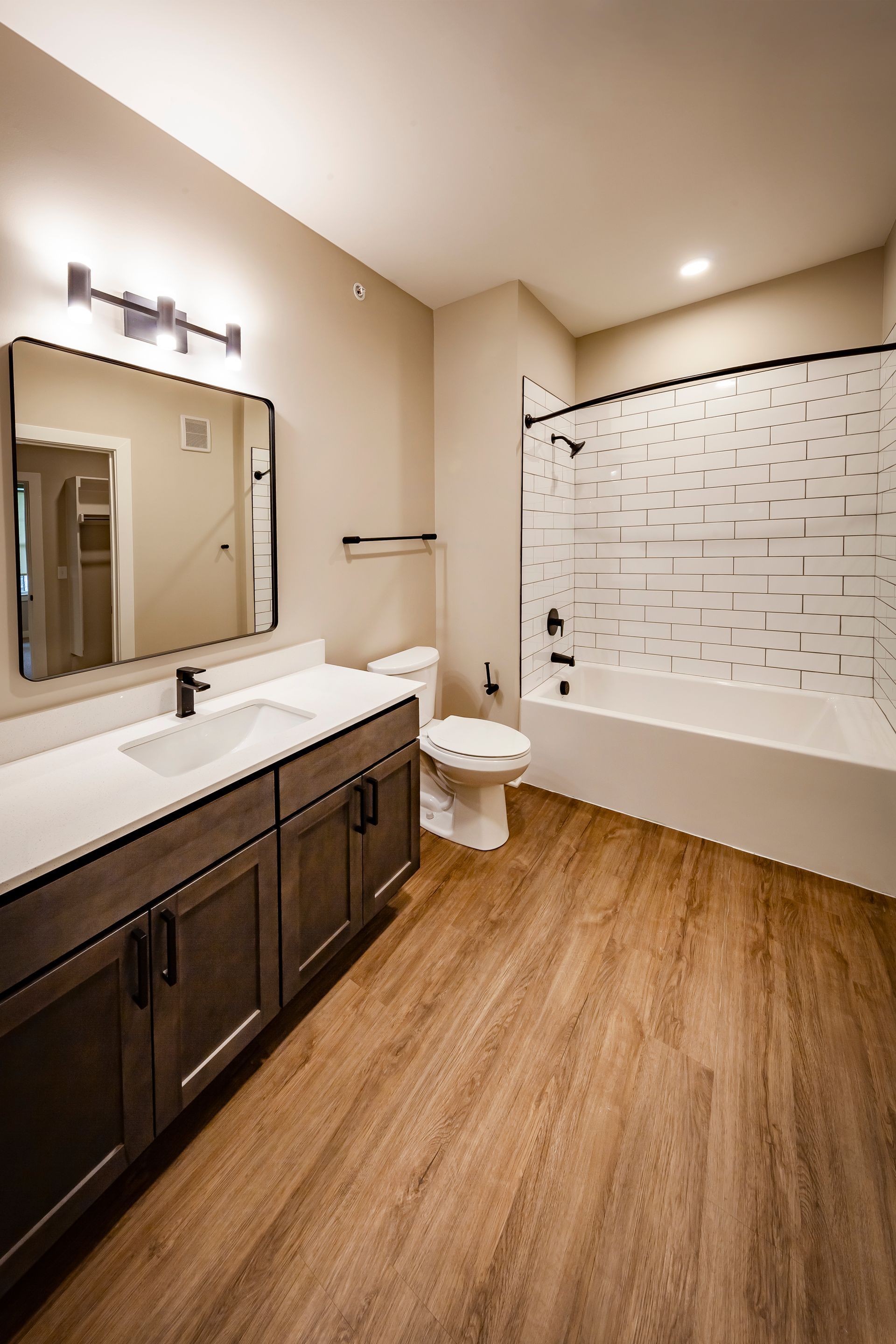 A bathroom with a toilet , sink , and bathtub.
