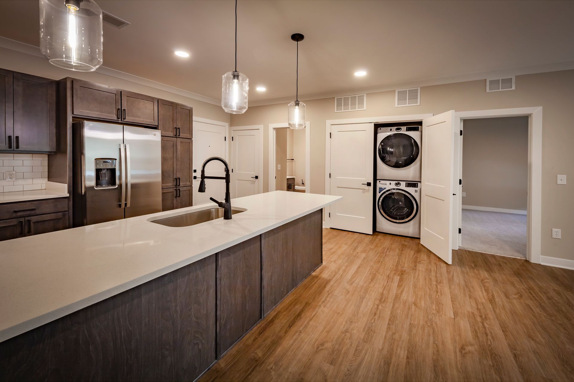 A kitchen with a washer and dryer stacked on top of each other.
