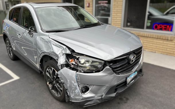 Vehicle with front end damage before repairs were performed by Modern Auto Body.