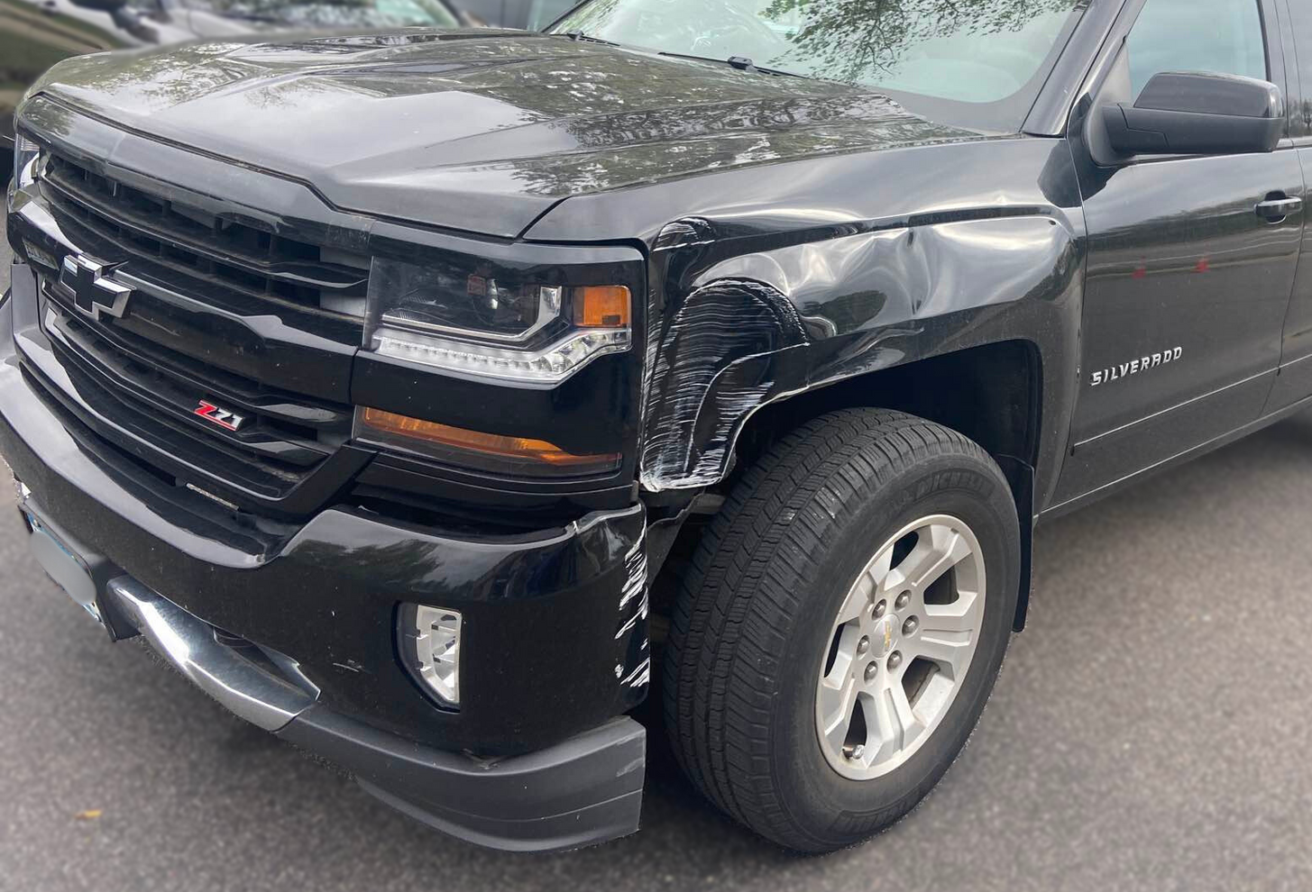 Vehicle with front end damage before repairs were performed by Modern Auto Body.