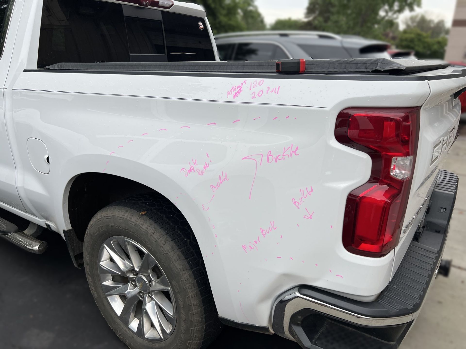  Marking the damage to the vehicle for blueprinting the auto body repairs that will be performed by Modern Auto Body. 