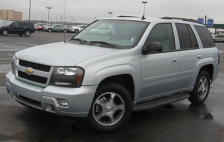 A silver chevrolet trailblazer is parked in a parking lot