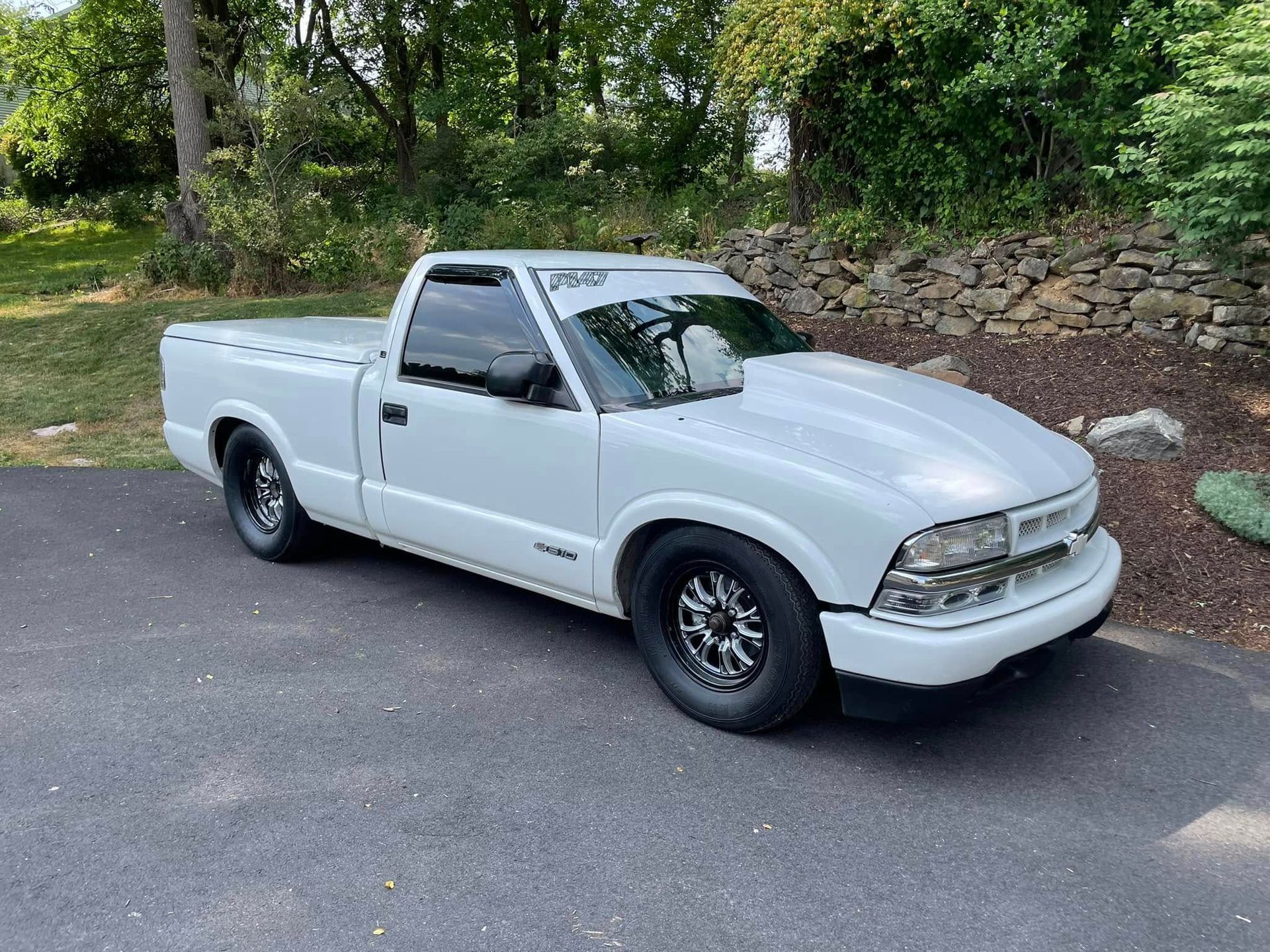 A white pickup truck is parked on the side of the road.