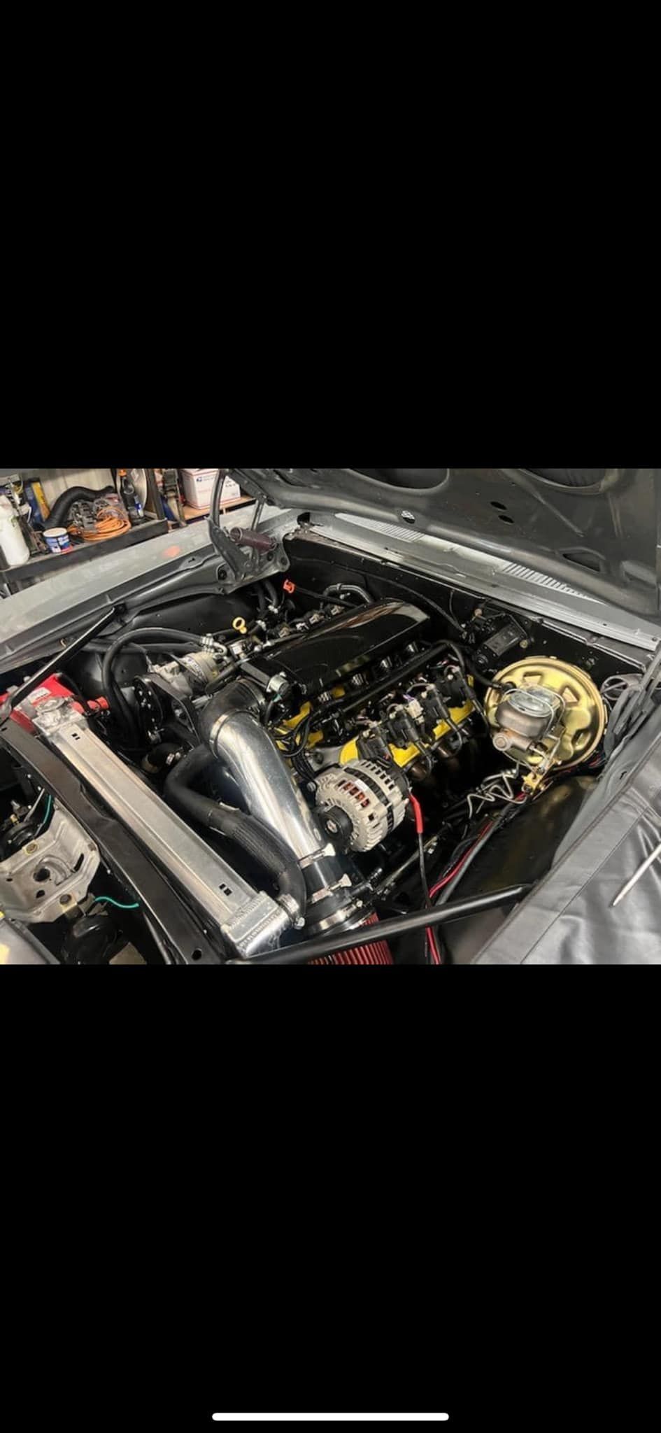 A close up of a car engine in a garage.