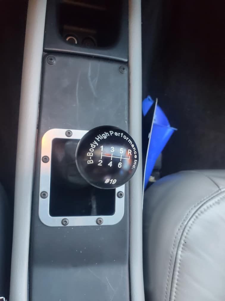 A close up of a shifter knob in a car