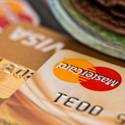 A close up of a mastercard card next to a visa card
