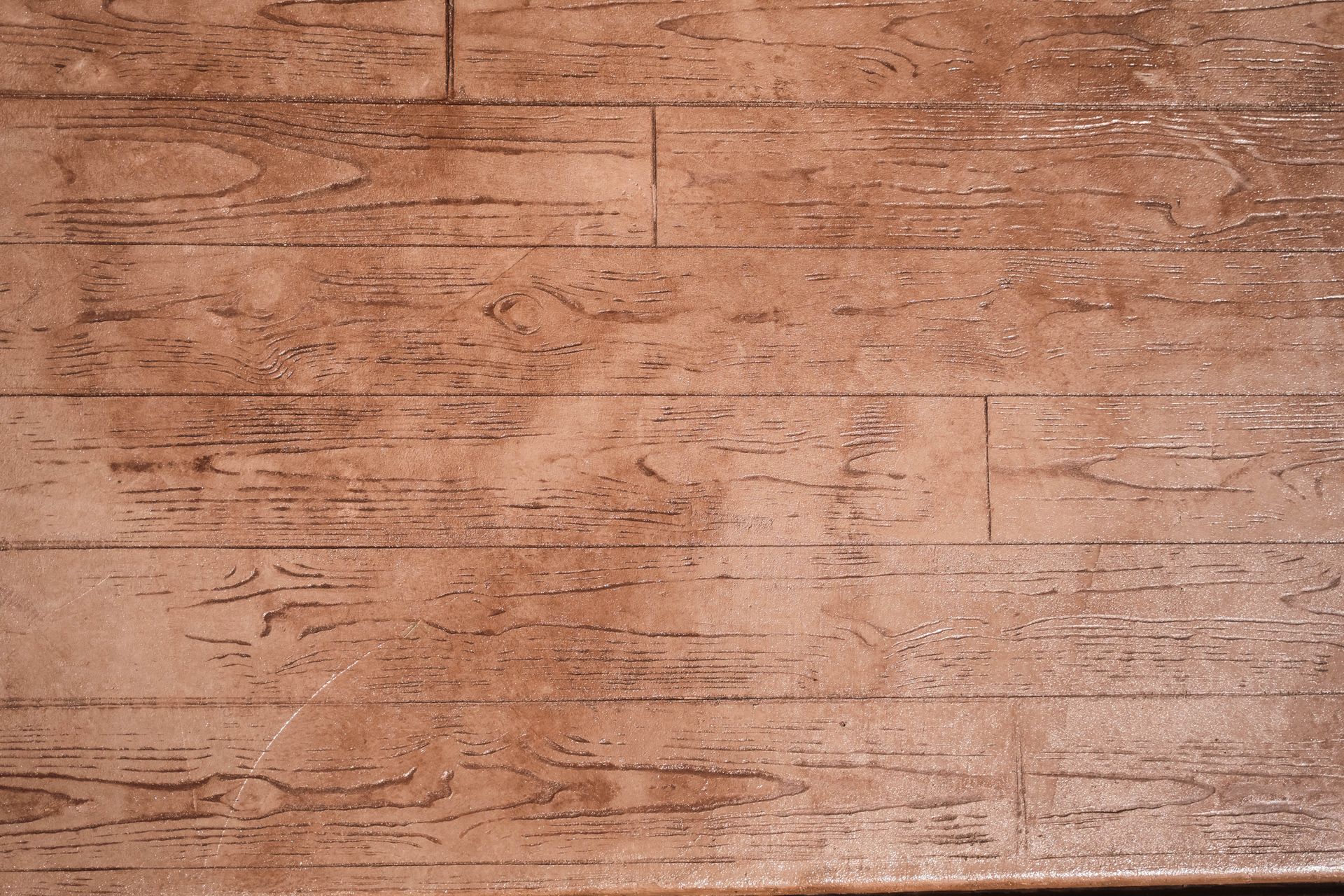 Brown concrete flooring with a wood plank pattern.