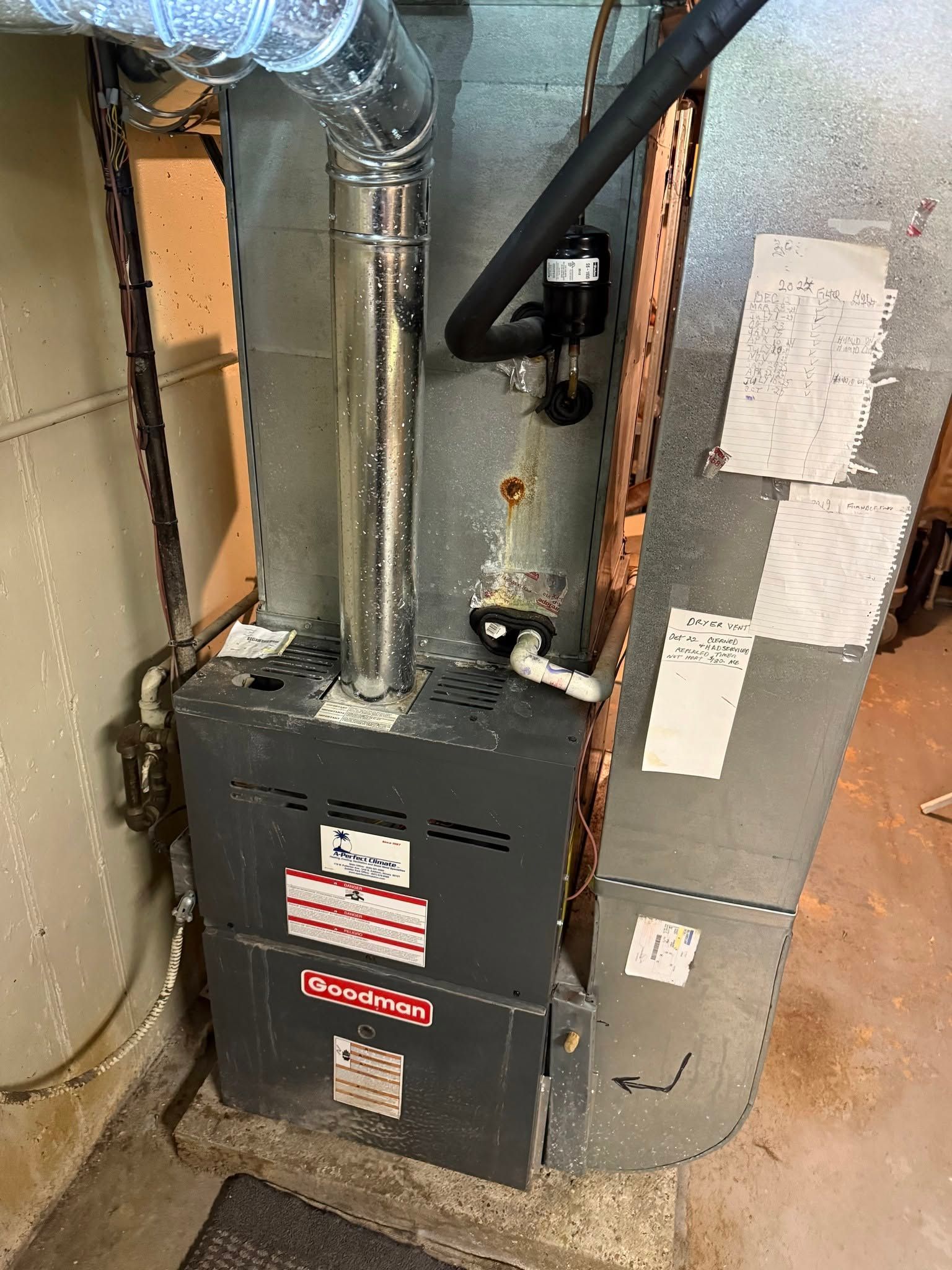 Furnace and HVAC ductwork in a basement utility area with exposed pipes and vents.