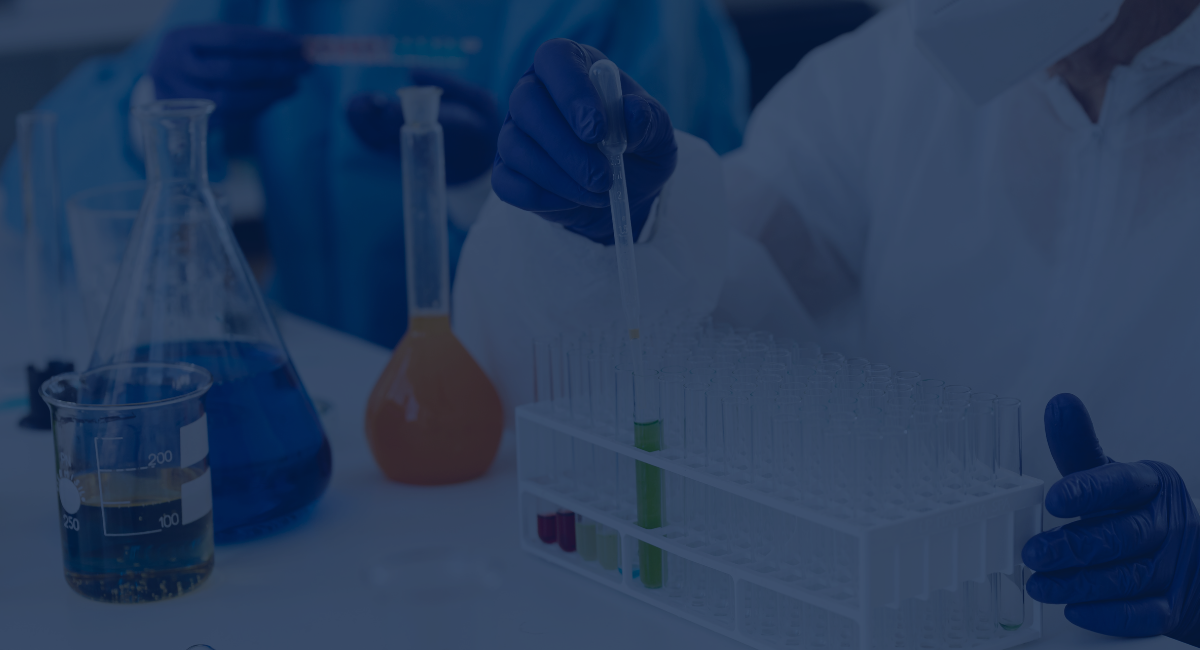 Blue-tinted lab scene with gloved hands handling test tubes beside beakers and flasks