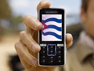 Hand holding a mobile phone displaying the Cuban flag on the screen