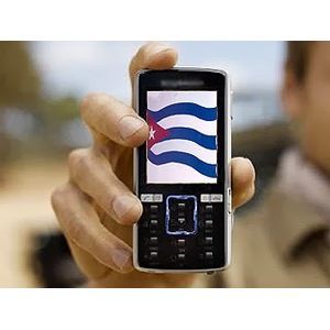 Hand holding a small cellphone showing the Cuban flag on its screen