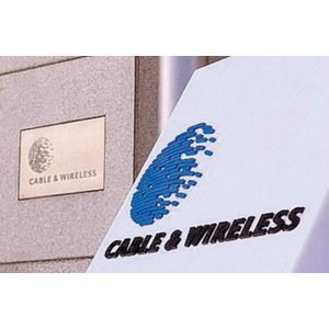 Cable & Wireless signs on a building exterior, with a blue logo and black lettering on white panel.