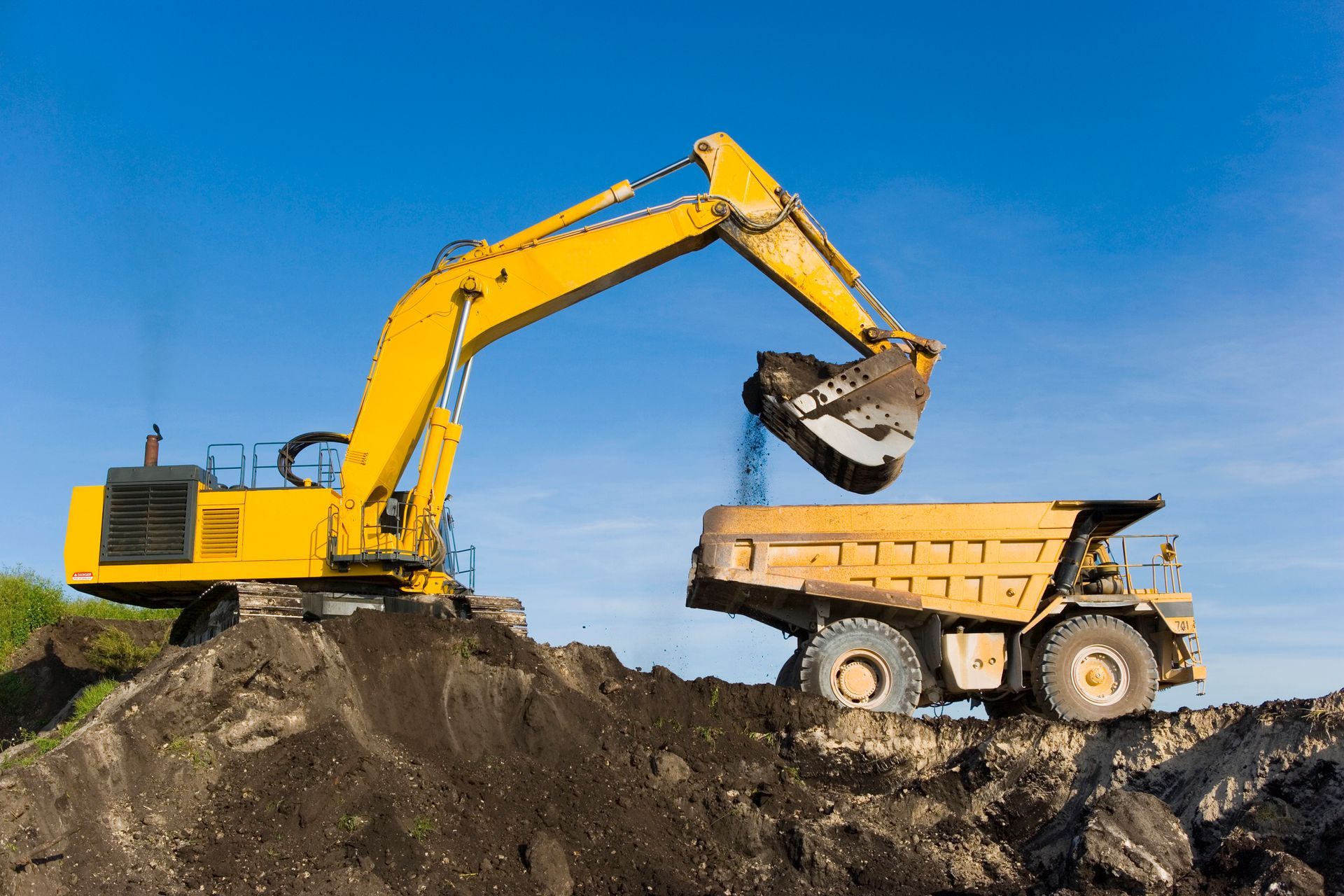 Excavator Transfering Soil To The Hauler — Honolulu, HI — David Yamada, LLC