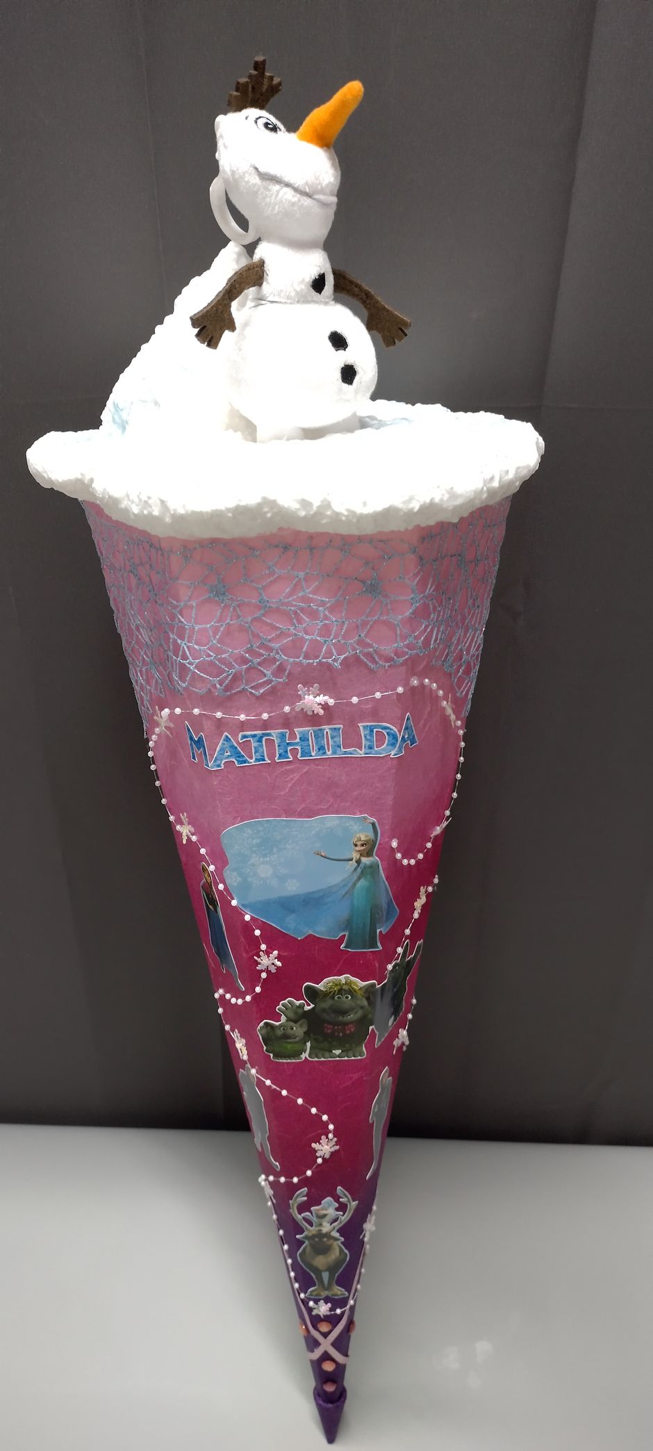Ein rosa Kegel mit einem Schneemann darauf