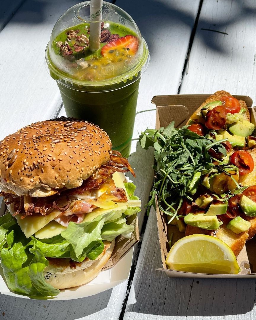 A Sandwich, a Smoothie and a Pizza Are on a Table — The Pass Cafe in Byron Bay, NSW