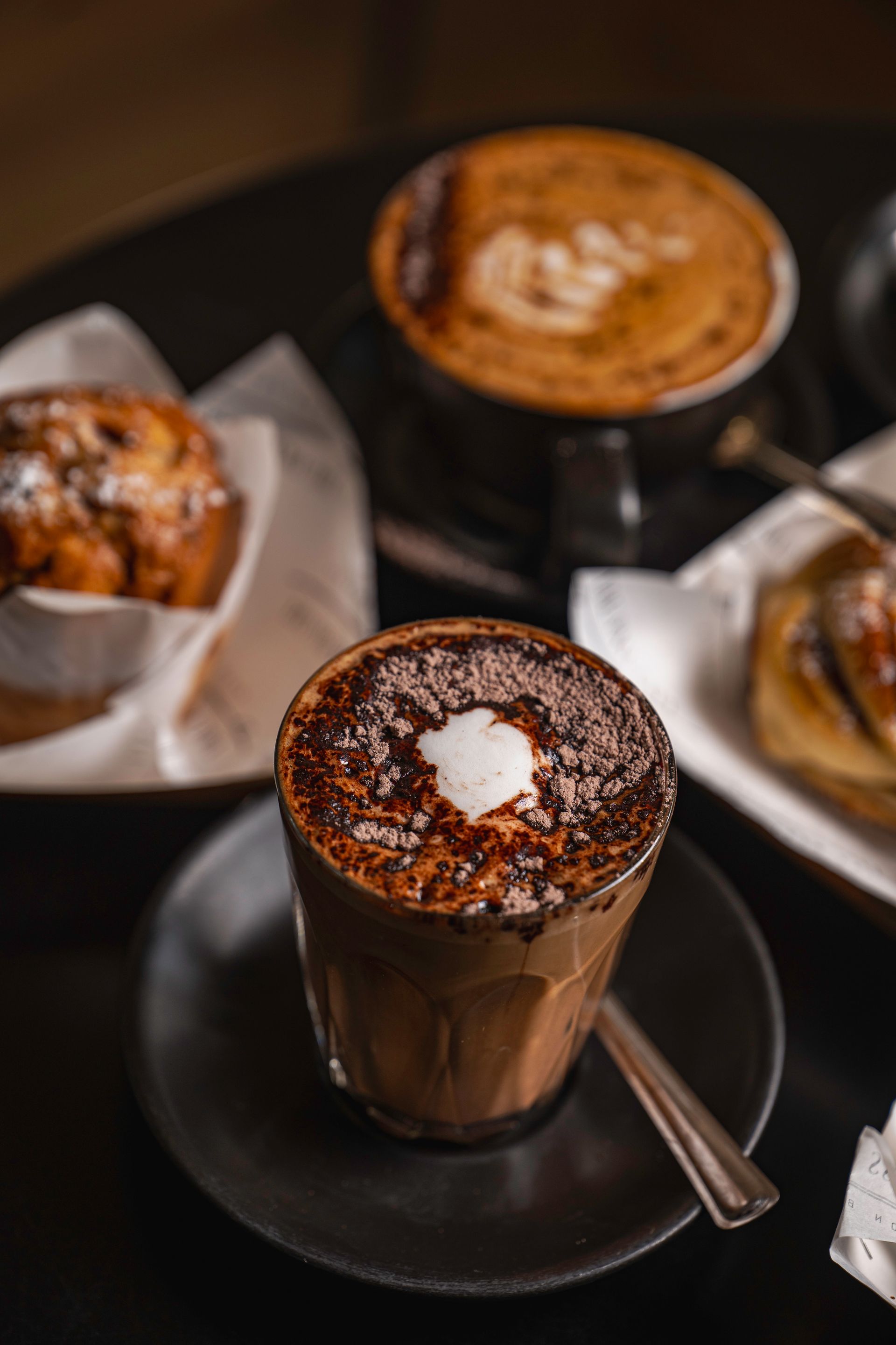A Cup of Hot Chocolate With Whipped Cream on Top is on a Saucer on a Table — The Pass Cafe in Byron Bay, NSW