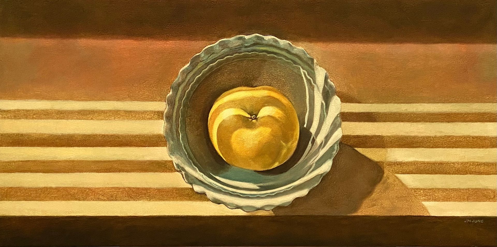 One yellow pearapple in a blue bowl sitting on a windowsill with light from Venetian blinds falling over it.