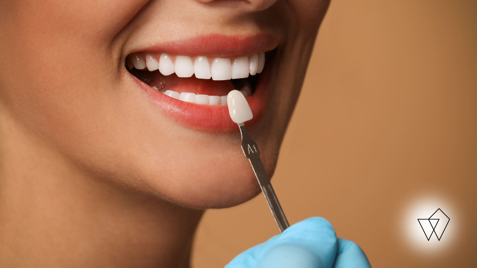 Close-up of a smiling mouth with a cotton swab applying lip product, wearing blue gloves