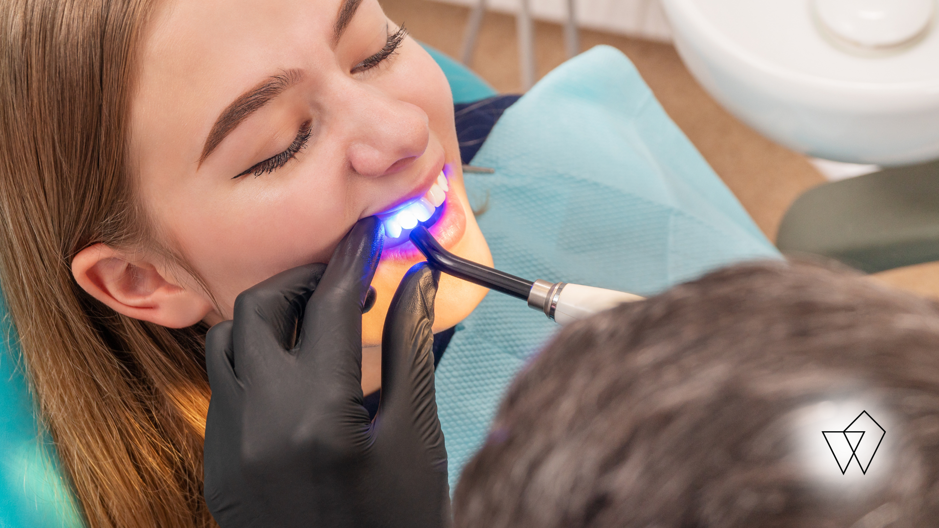 Dental procedure with blue light on a patient’s teeth in a clinic