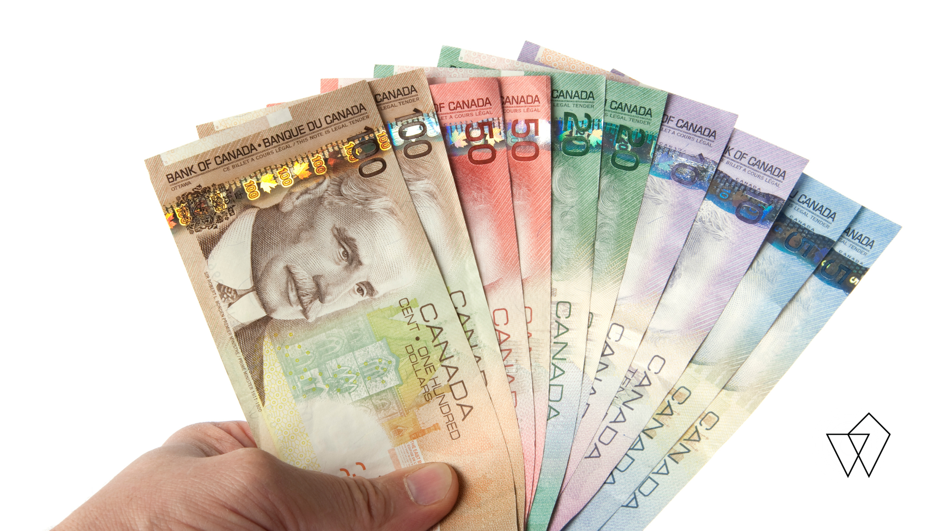 Hand holding a fan of colorful banknotes against a white background