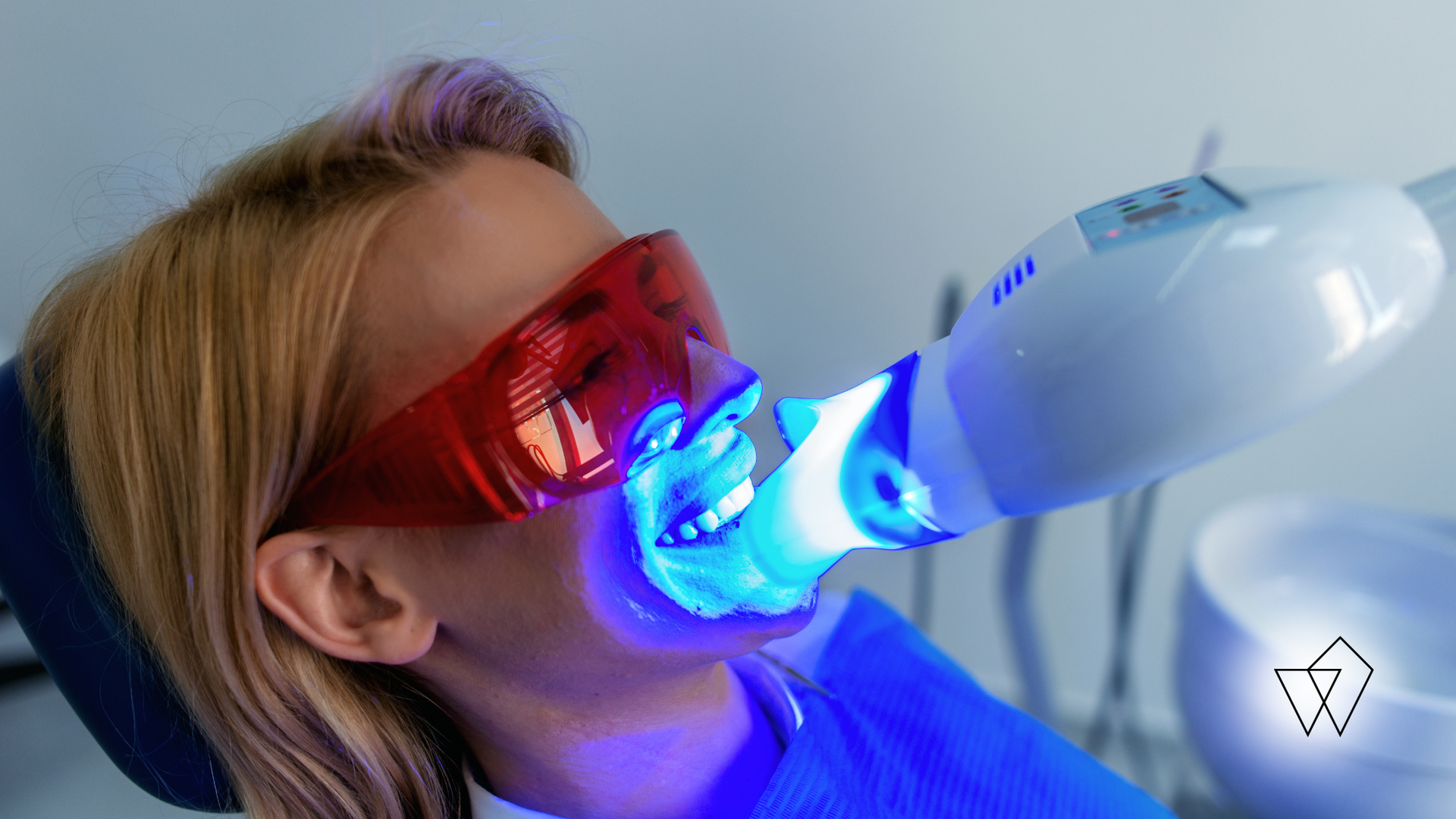 Person using a red and blue light therapy mask on the face in a close-up shot