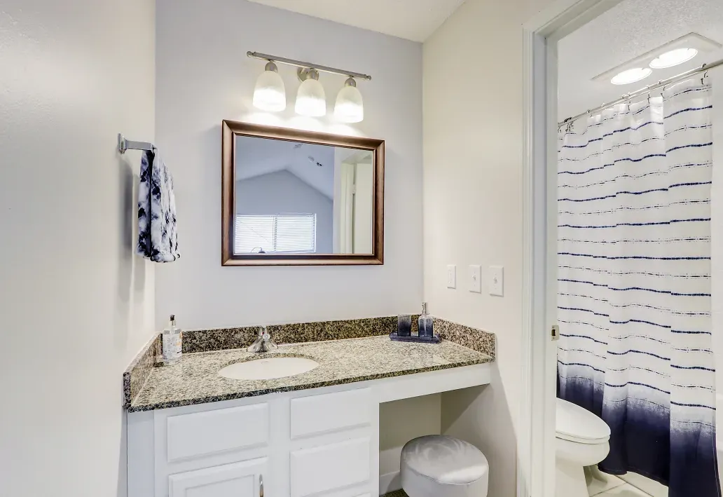 Interior of bathroom with white cabinetry