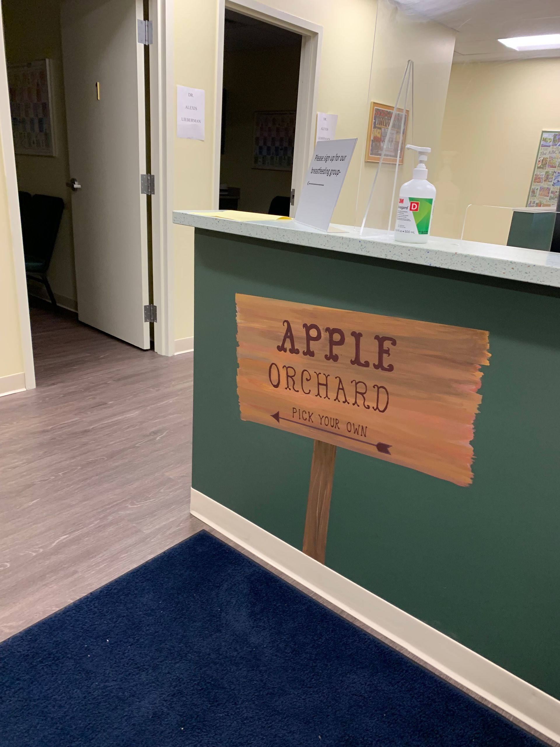 A wooden sign that says apple orchard on it at Advocare Fairmount Pediatrics
