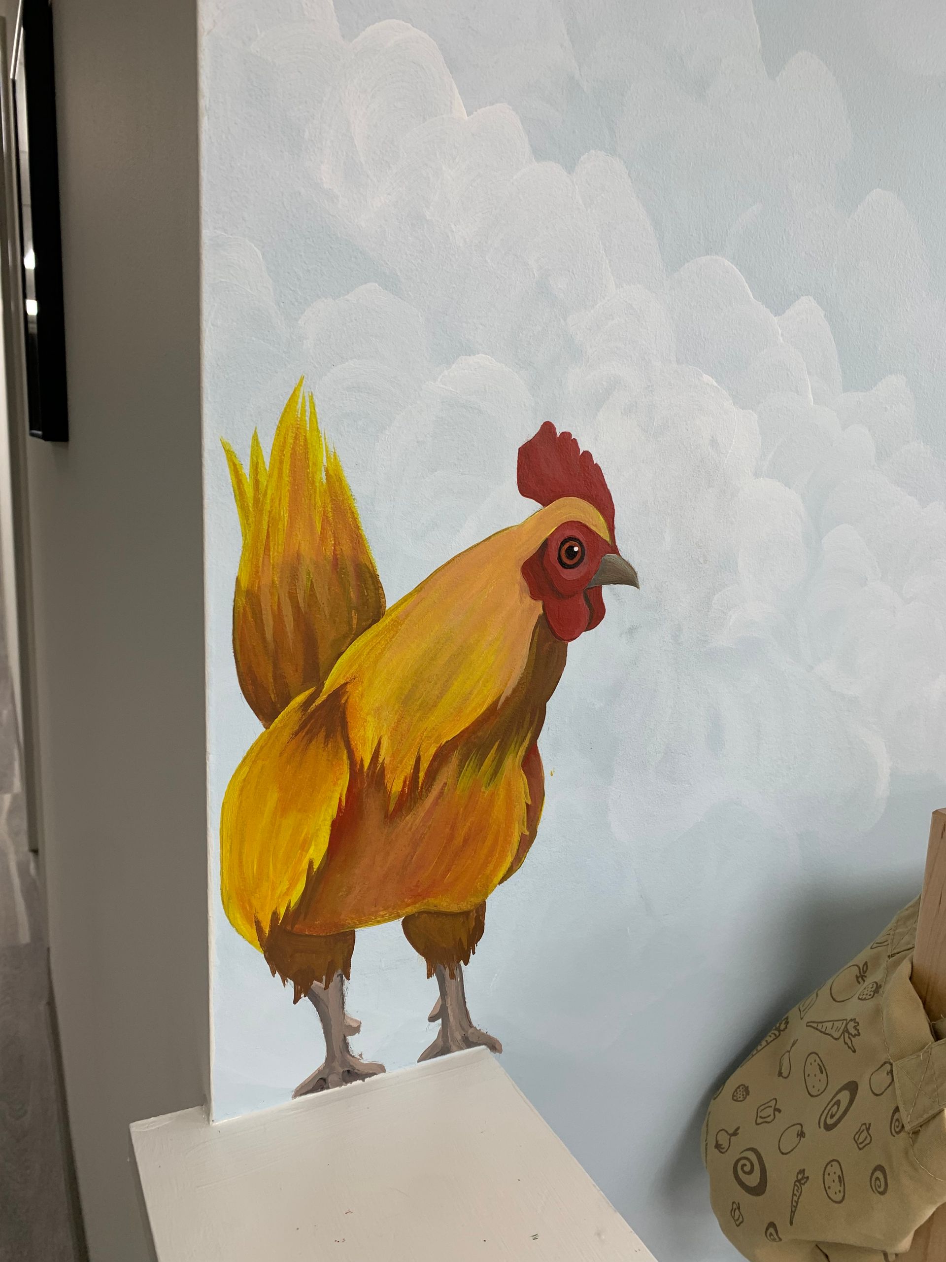 A painting of a yellow rooster with a red crest at Advocare Fairmount Pediatrics