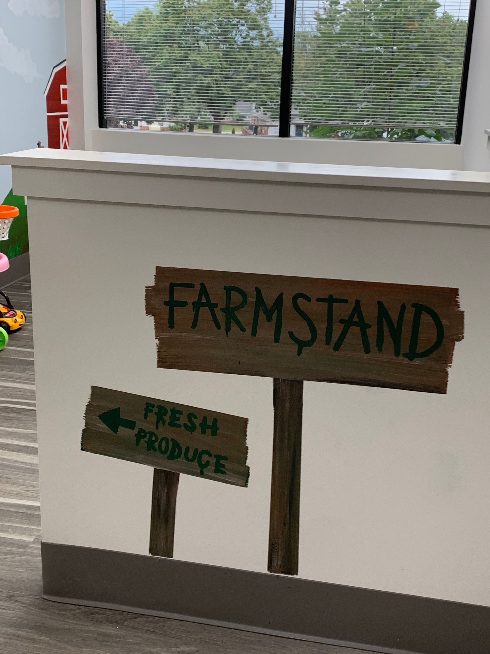 A sign on a wall that says farmstand fresh produce at Advocare Fairmount Pediatrics