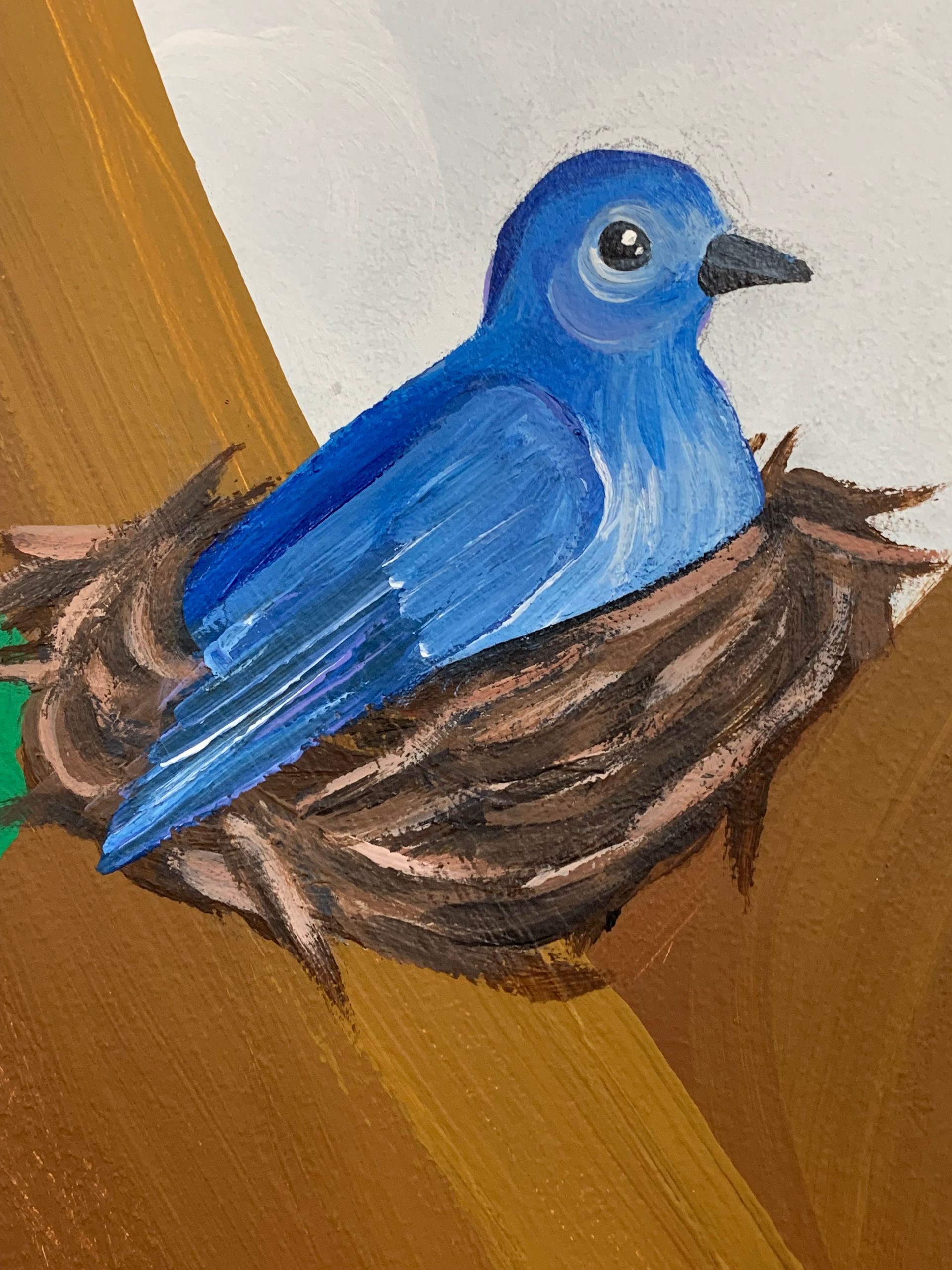 A blue bird is sitting in a nest in a painting at Advocare Fairmount Pediatrics