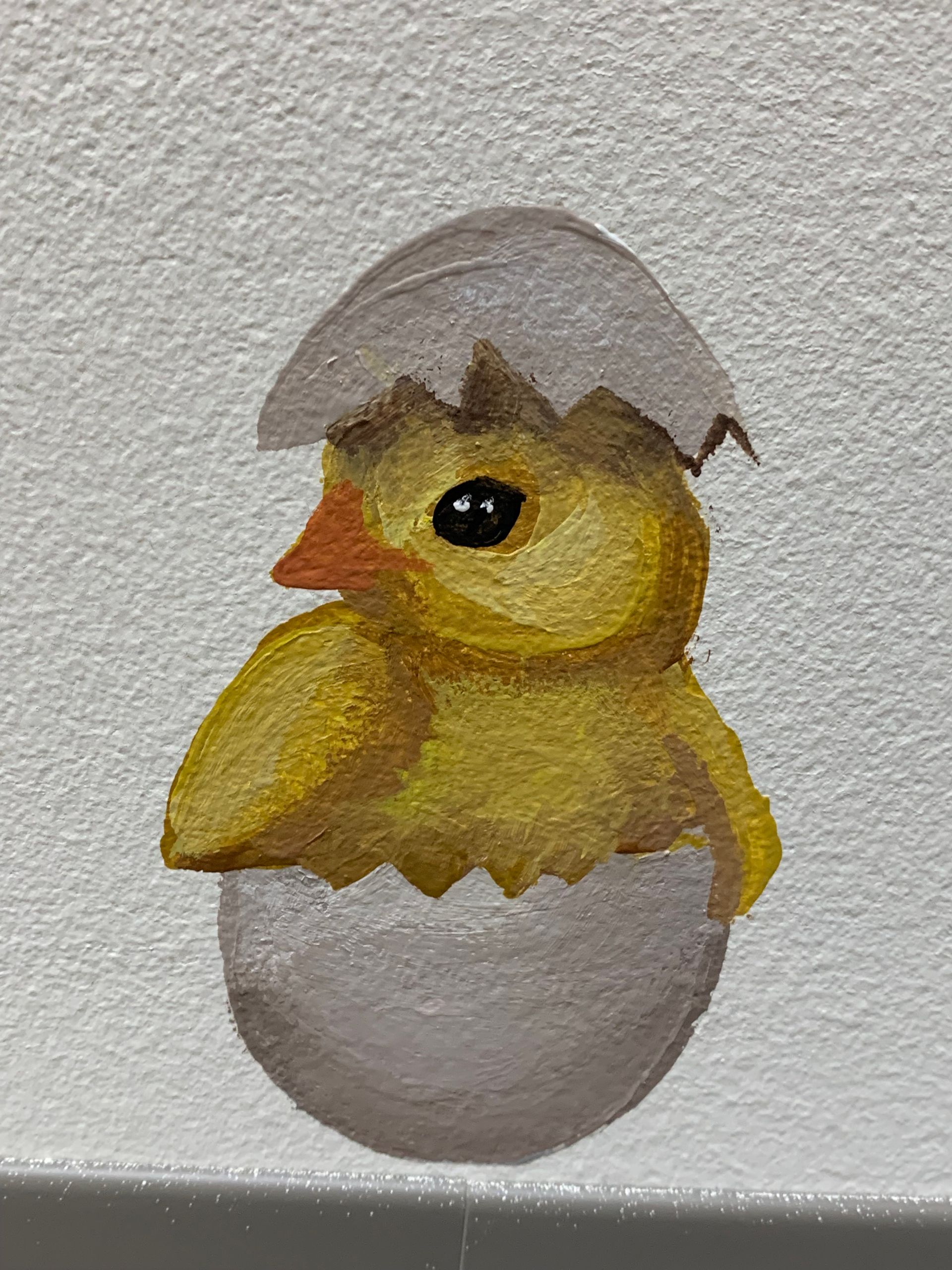 A painting of a baby chicken coming out of an egg at Advocare Fairmount Pediatrics