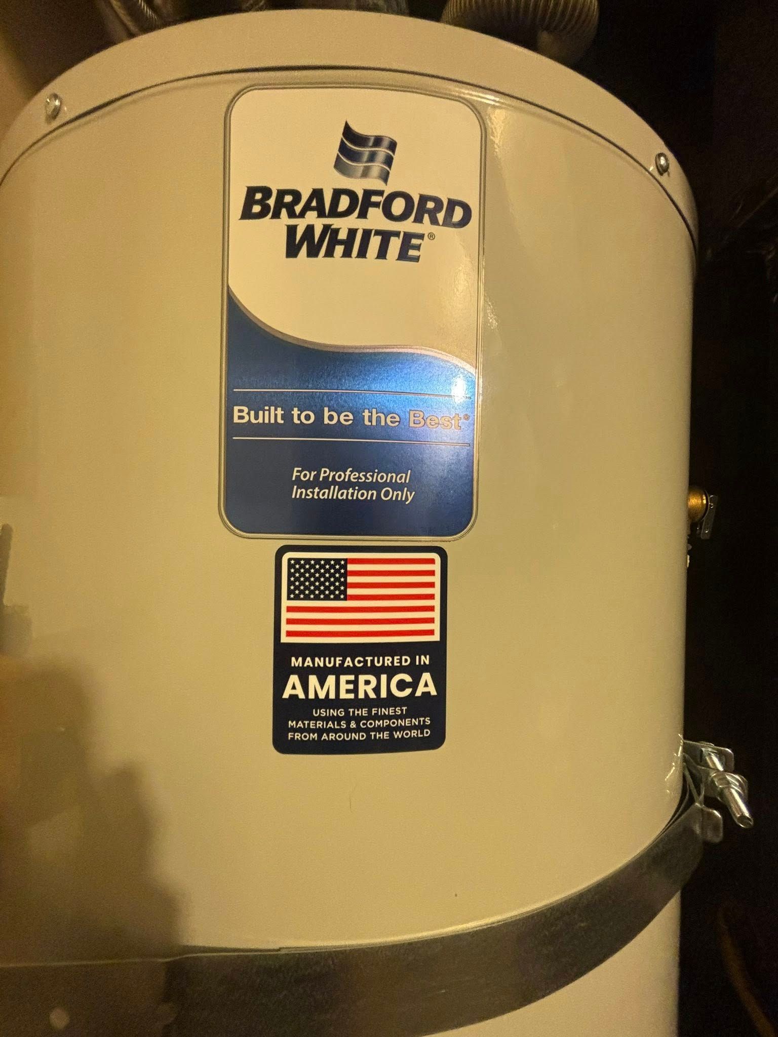 A beige Bradford White water heater tank featuring a brand logo and a 