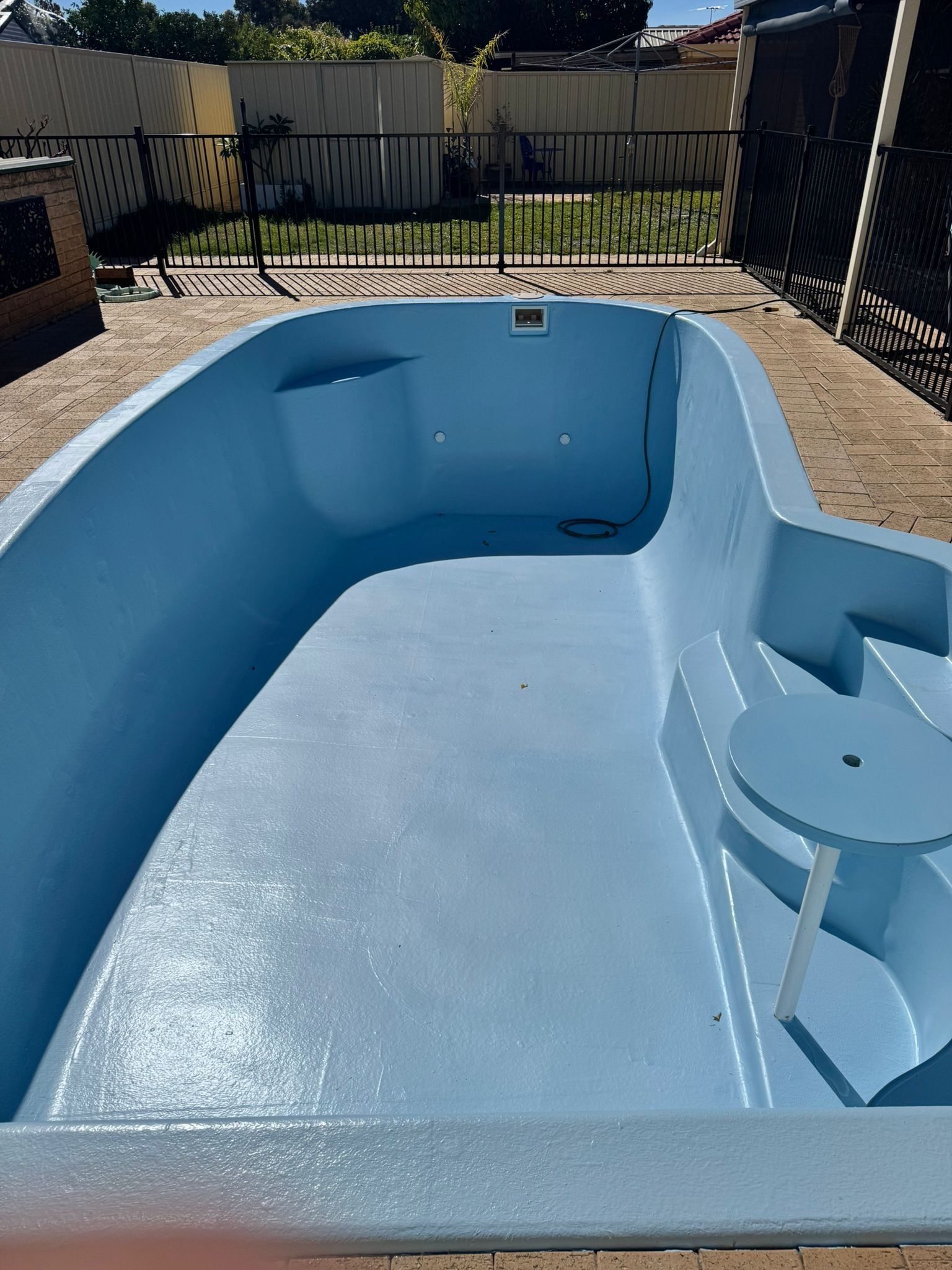 After image of a swimming pool which requires resurfacing.