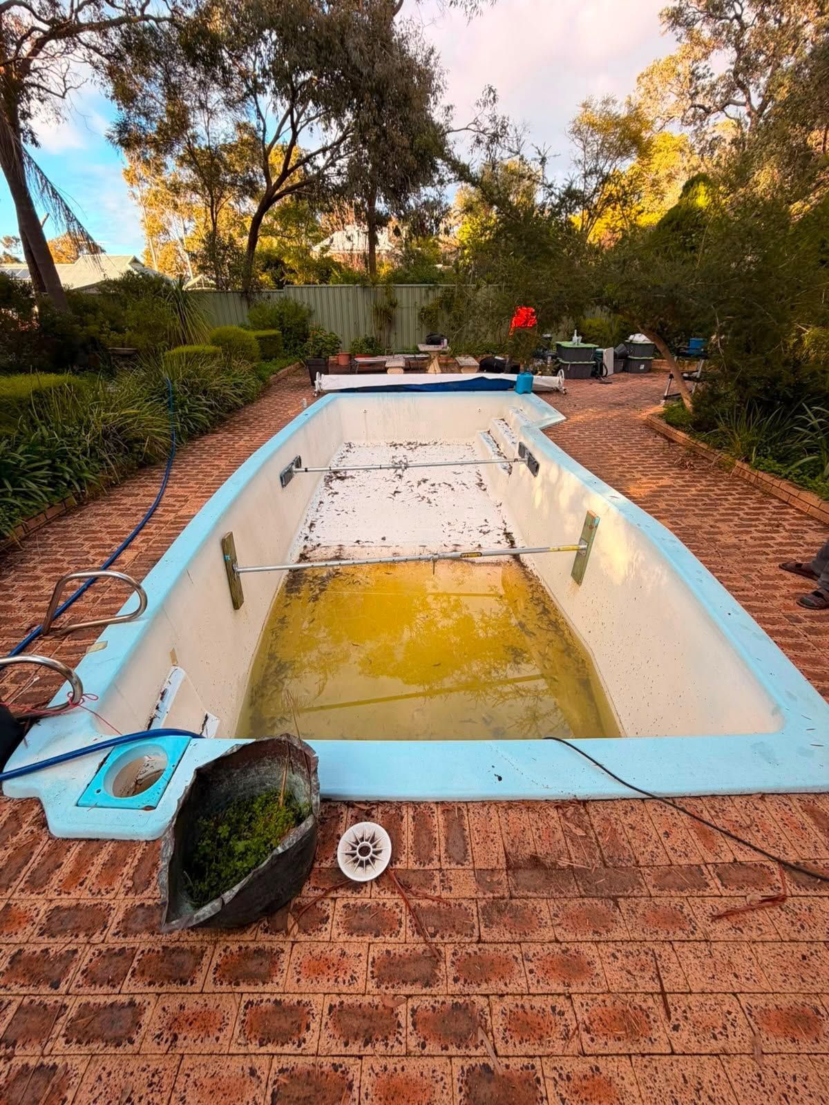 Before image of a swimming pool which requires resurfacing.