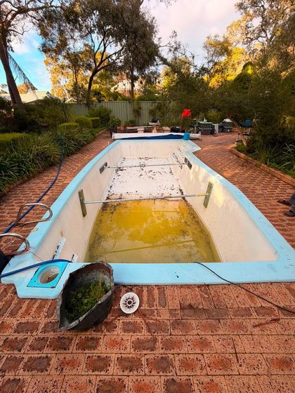 Before image of a swimming pool which requires resurfacing.