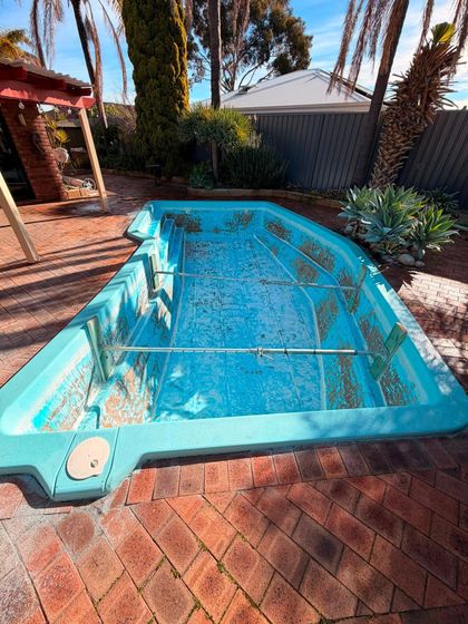 Before image of a swimming pool which requires resurfacing.