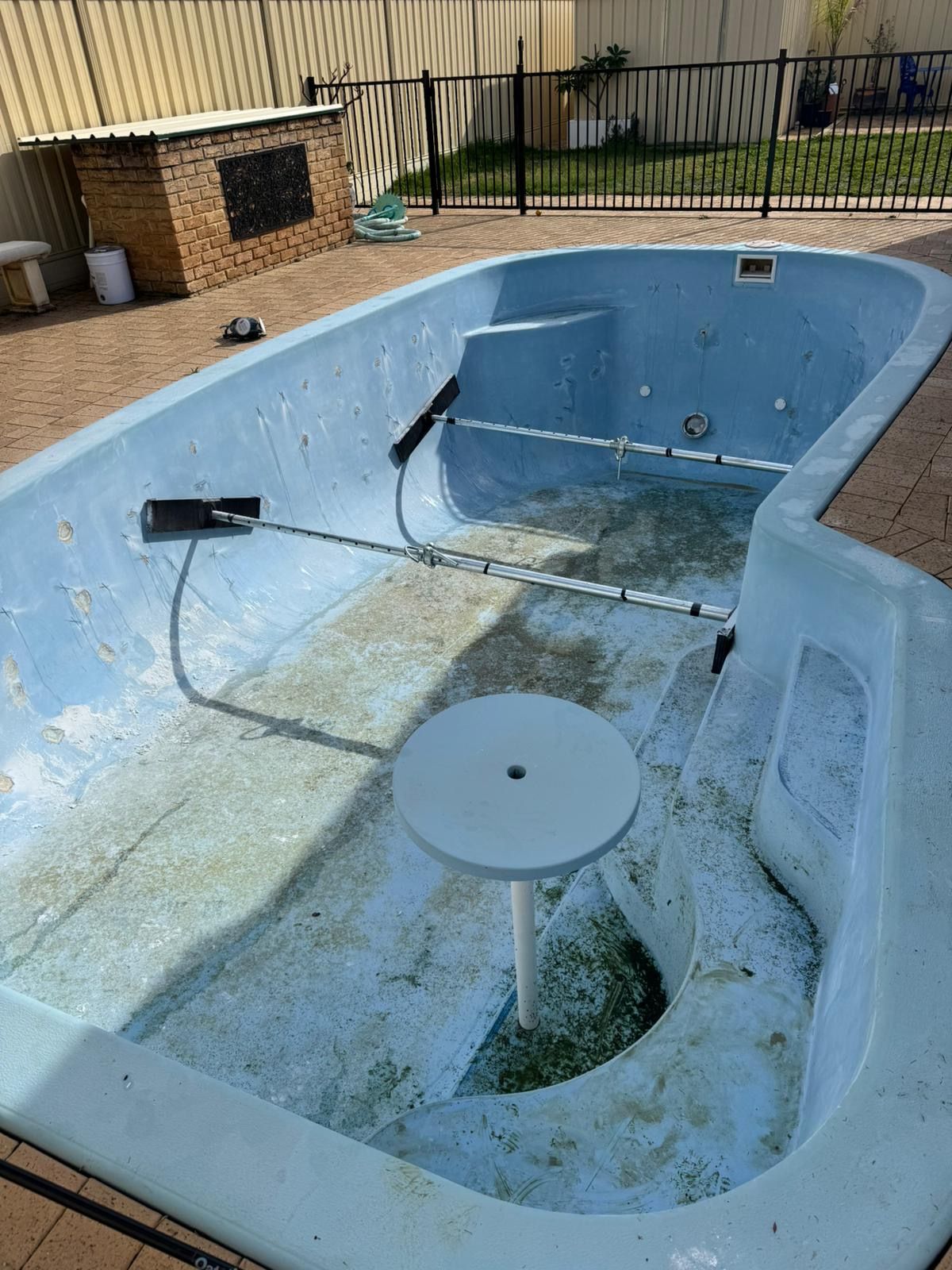 During image of a swimming pool which requires resurfacing.